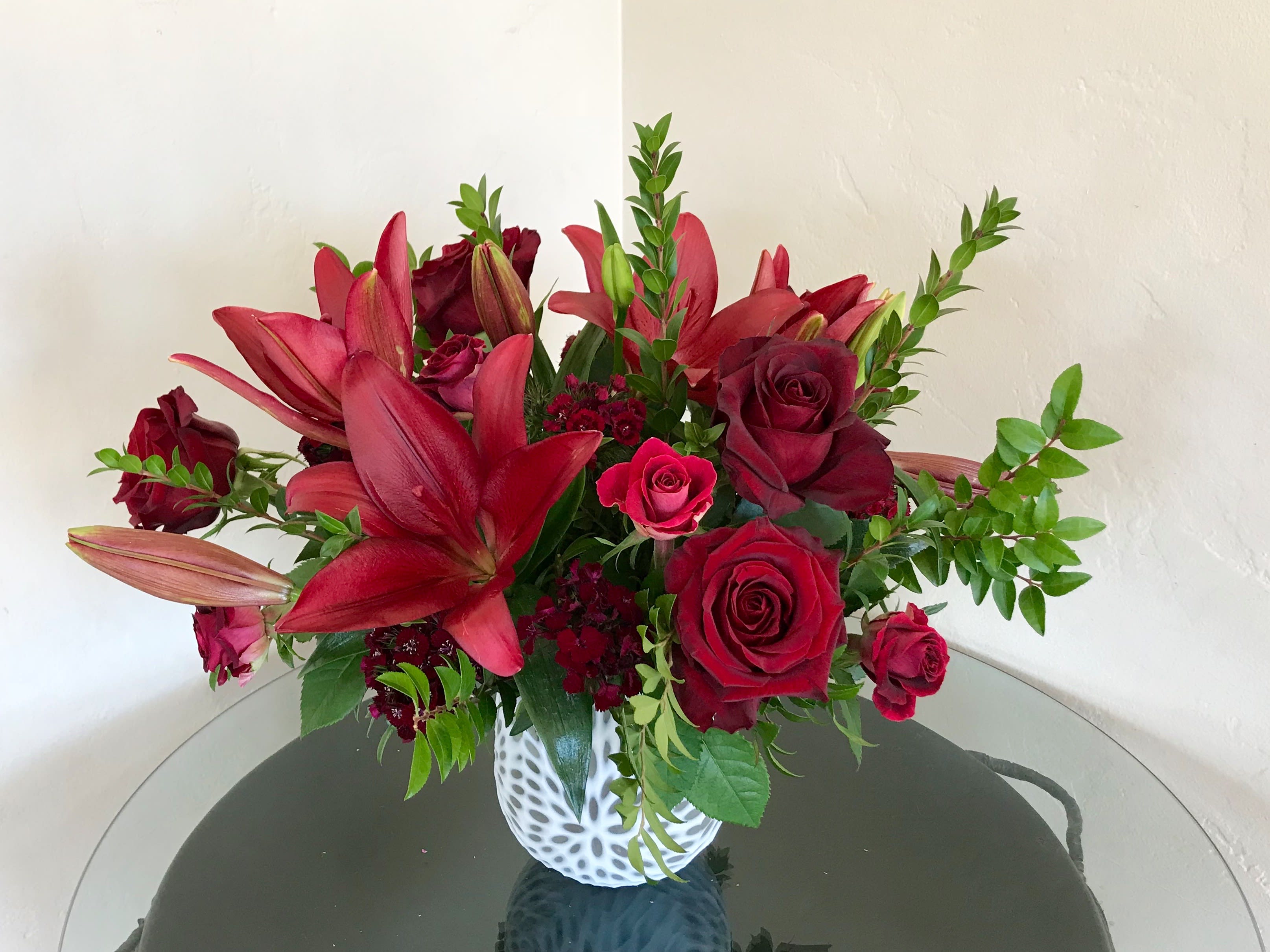 All the Red - Beautiful deep red mix of Lilies, Black Pearl Roses, mini red roses &amp; flowering dianthus. 