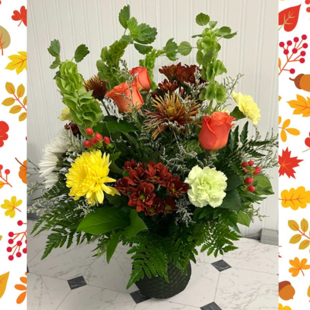 Mixed flower arrangement in a black vase with roses and chrysanthemums