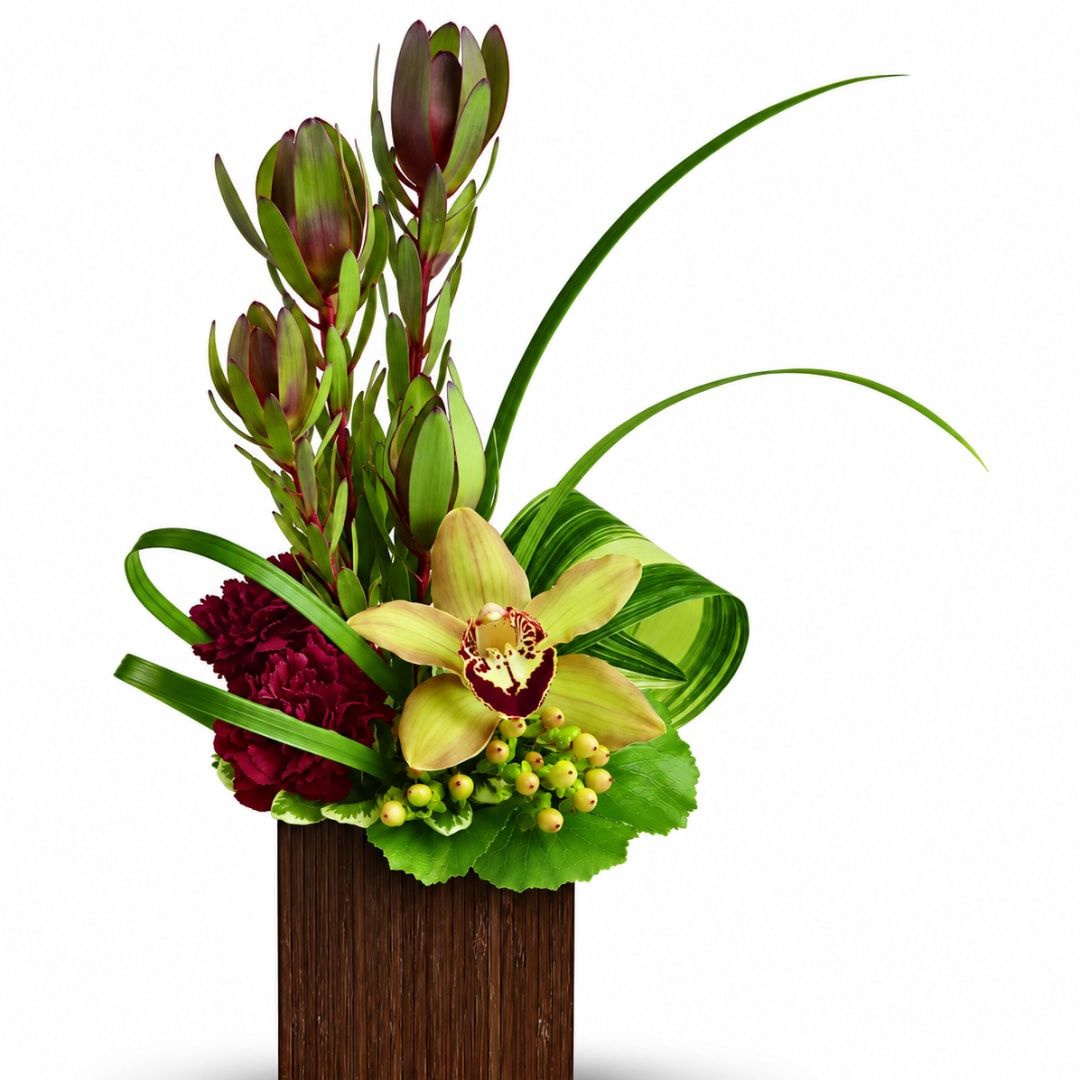 Tropical arrangement with orchids, burgundy carnations, and a tall vase