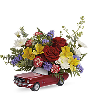 Beautiful Ford Bouquet - This '65 Mustang is sure to rev' things up! The sporty ceramic keepsake vase is hand-glazed and arranged with a colorful bouquet to celebrate any cool occasion. Red roses, yellow alstroemeria, miniature peppermint carnations, white cushion spray chrysanthemums and blue sinuata statice are arranged with spiral eucalyptus, leatherleaf fern and lemon leaf. Teleflora's Beautiful Ford Bouquet is delivered in a '65 Ford Mustang Keepsake.