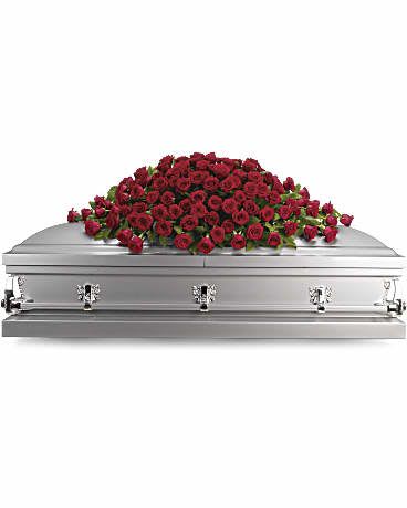 Red rose casket spray on a silver casket