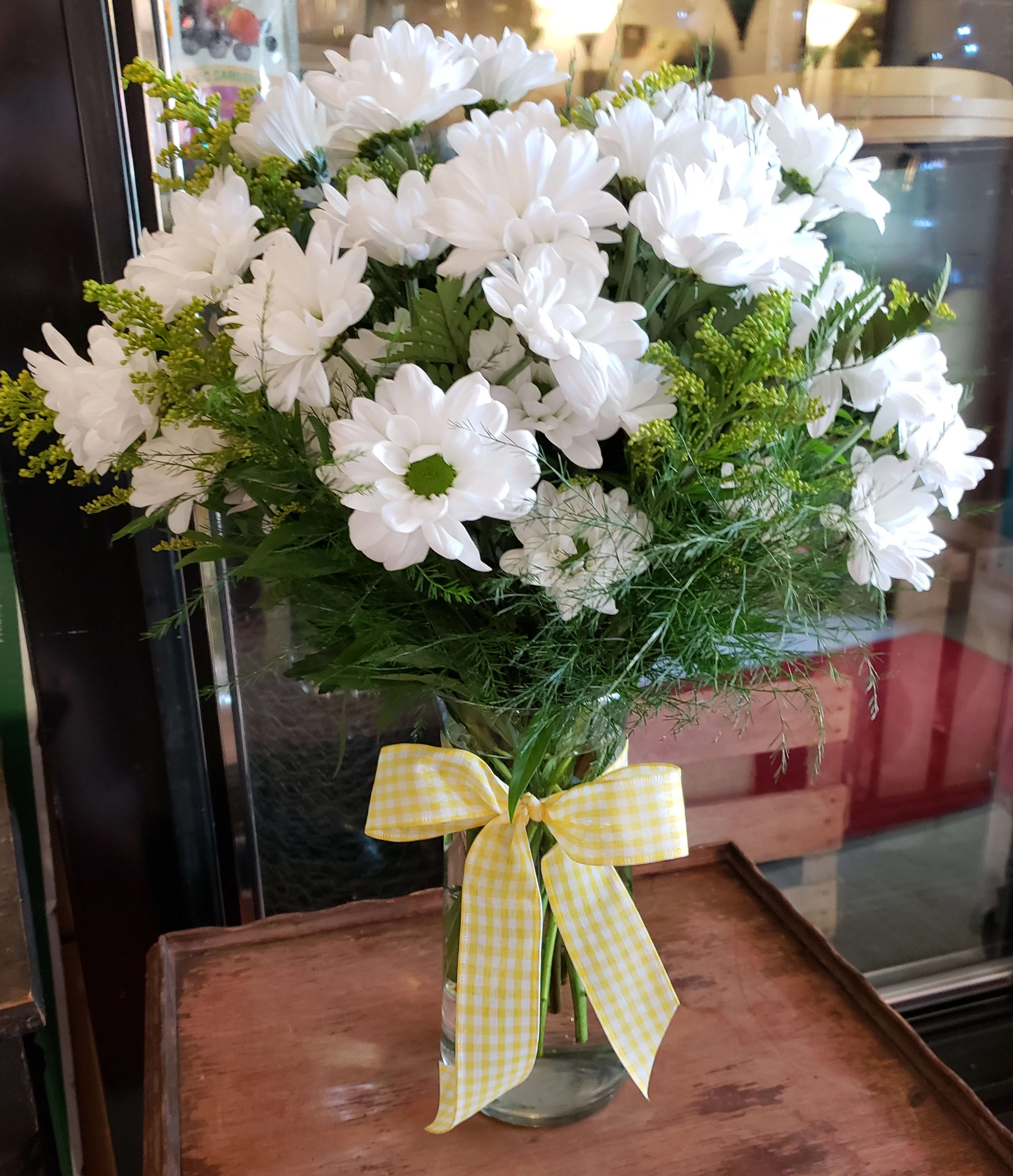 Daisy Daze - A sparkling glass vase overflowing with sun-kissed daisies is a sure-fire way to brighten anyone's day!