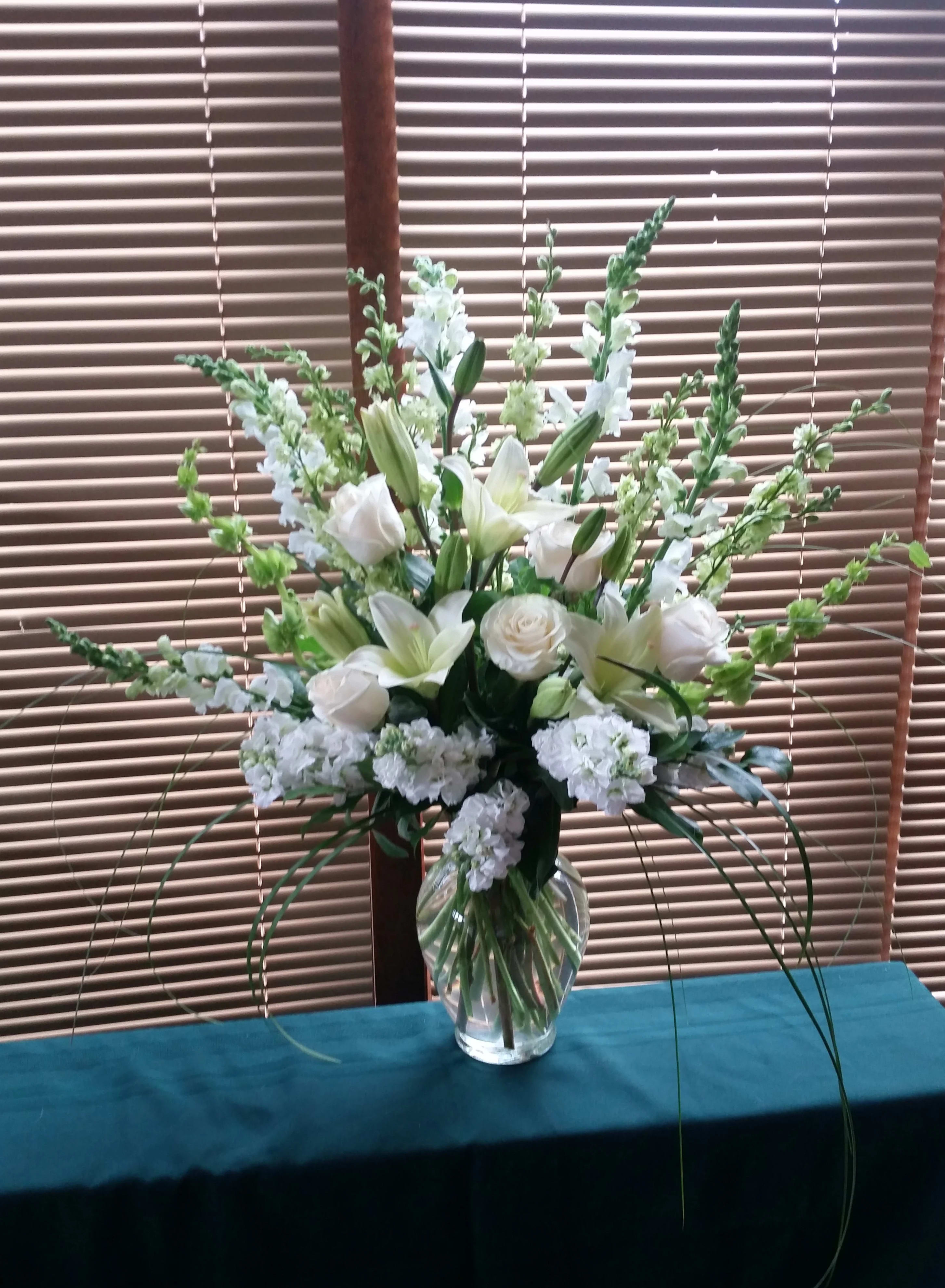 Pure Light - There is nothing quite as pleasing to the eye as the sweet simplicity of white flowers. And this stylish bouquet of all-white flowers – including lilies, roses, stock and more – is a lovely gift for any season of the year.