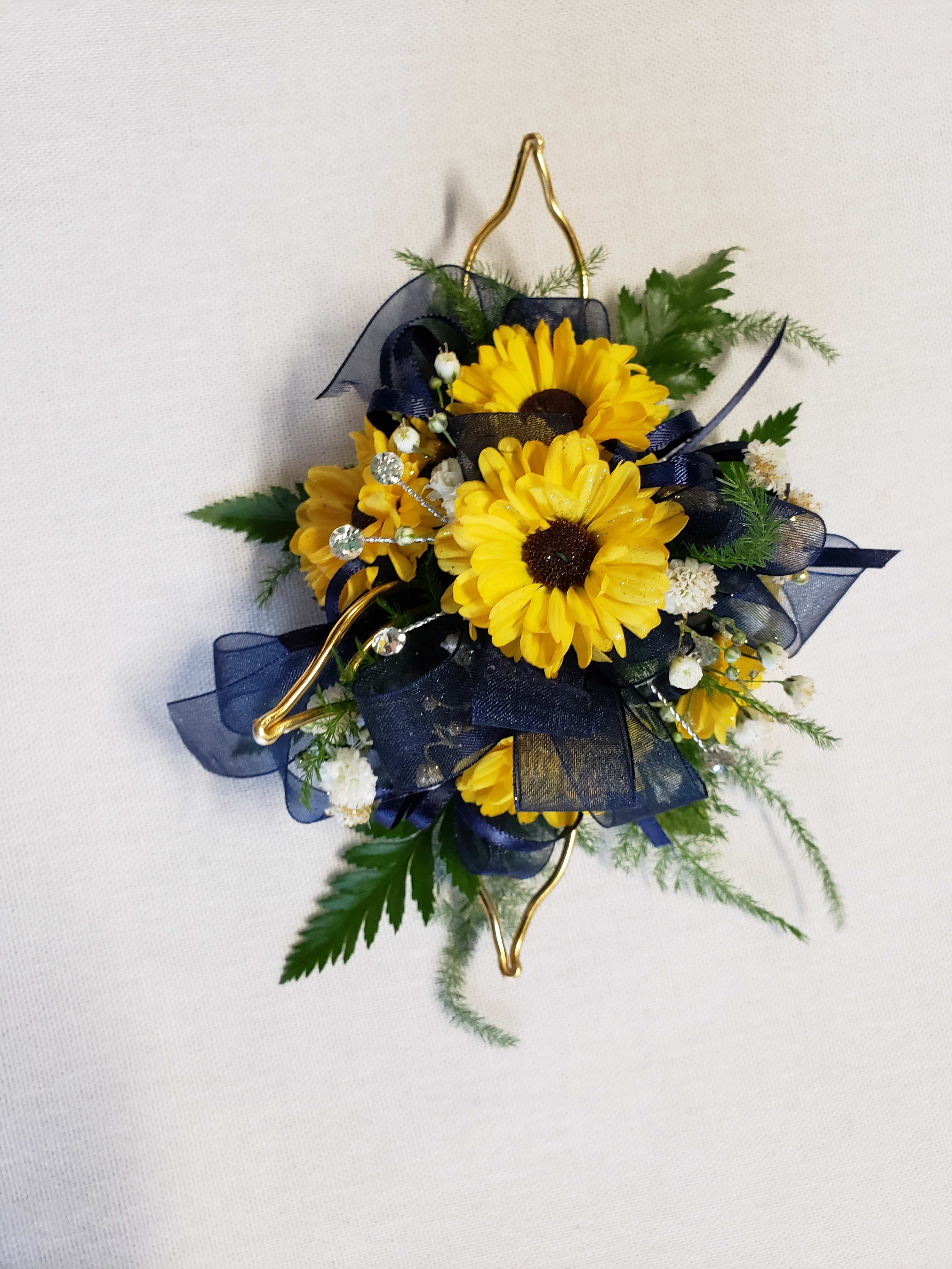 Yellow daisy corsage with navy ribbon and gold accents