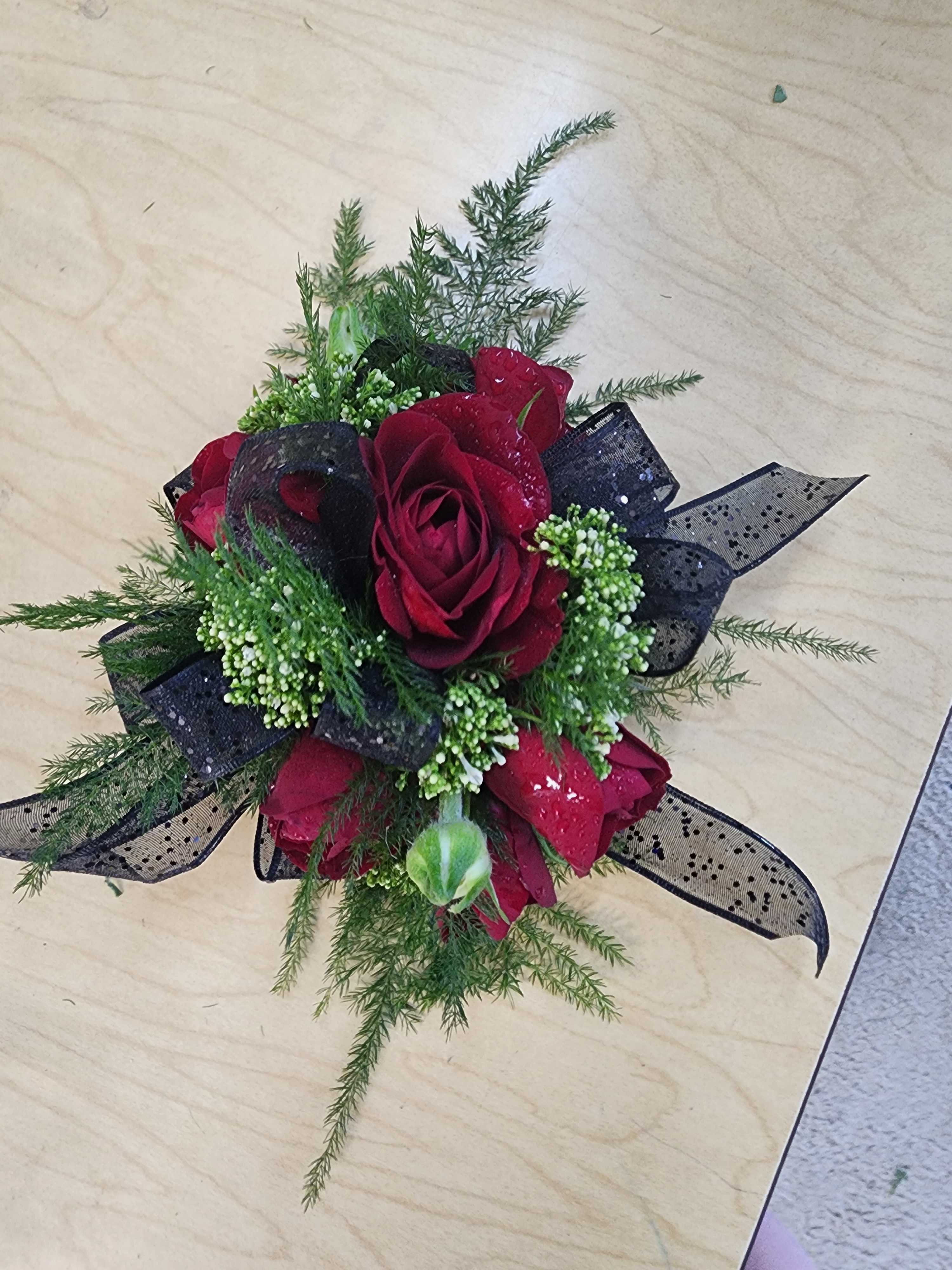 Red rose bouquet with black ribbon and greenery
