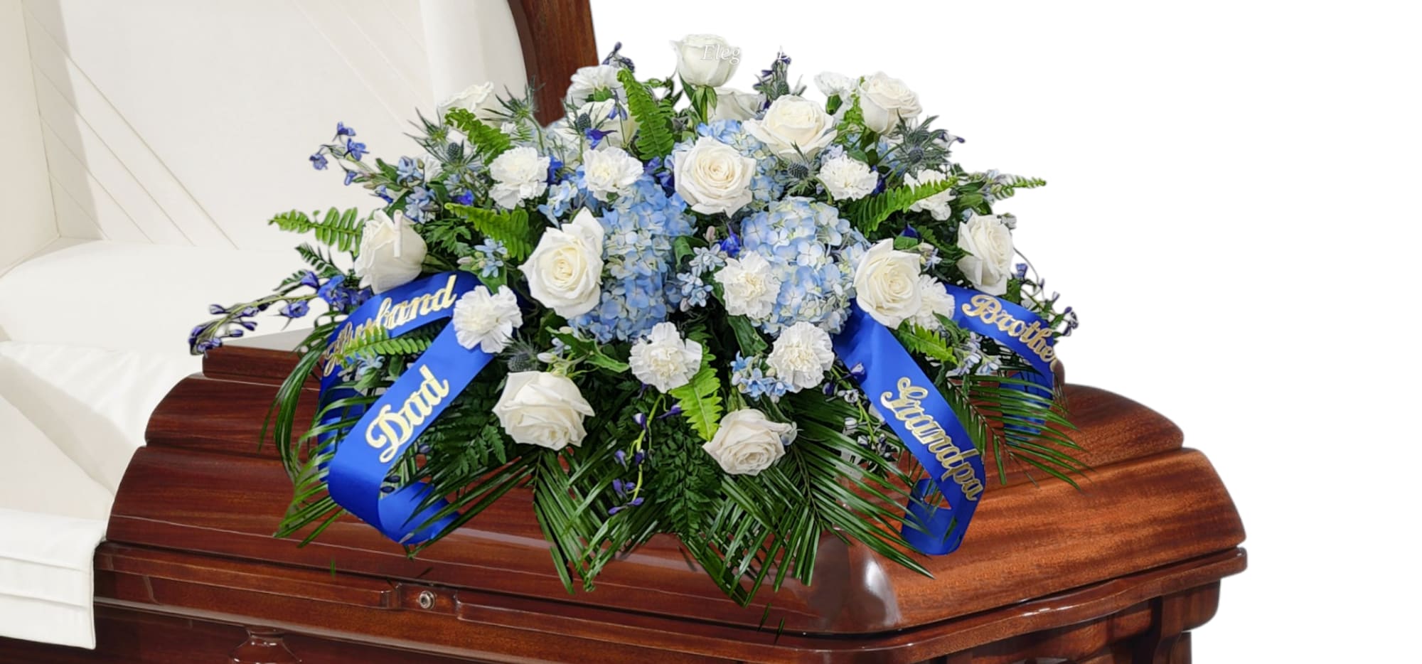 White rose and blue hydrangea casket spray with blue ribbons