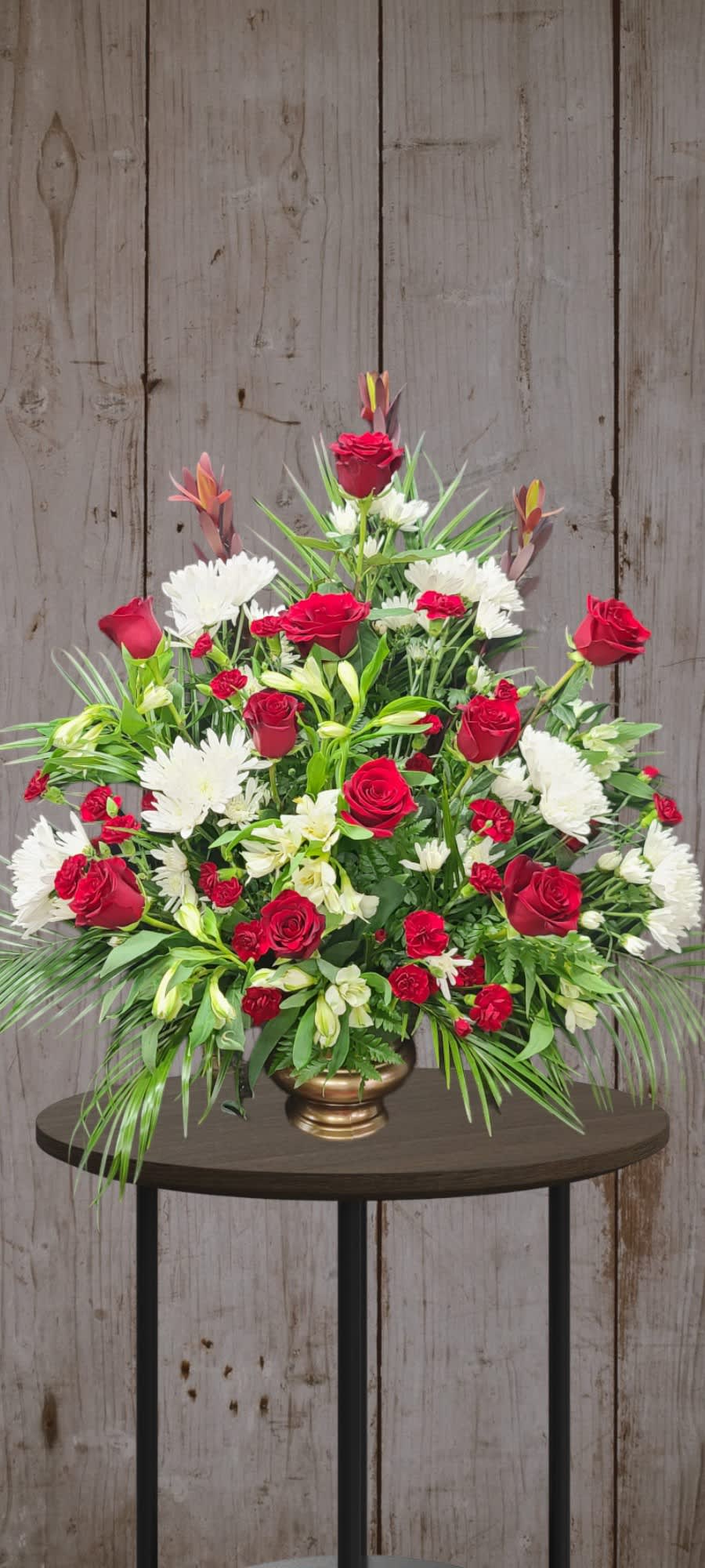 Traditional Funeral Urn Red &amp; White - Large and lush. Traditional and graceful. Roses, Carnations, chrysanthemums, and Alstroemeria  are in beautiful balance. 