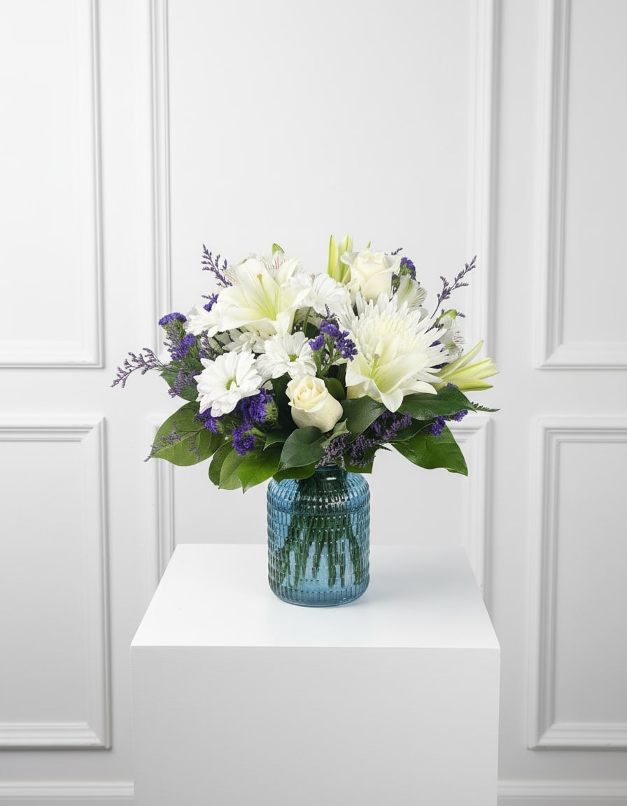 Quiet Comfort - Handcrafted with care, the Quiet Comfort arrangement creates a serene and comforting display that honors the memory of a loved one while offering support to family and friends. Its classic color palette and beautiful design make it a meaningful choice for funeral services, memorial gatherings, or as a thoughtful sympathy gift sent to the home.  Please Note: Standard Delivery for this product occurs in the afternoon, between 2:30pm and 7pm. If you need it by a certain time, there is an option to select a timed window for scheduled deliveries.