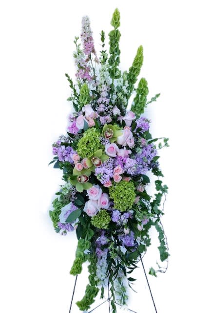Tall floral standing spray with pink, purple, and green blooms