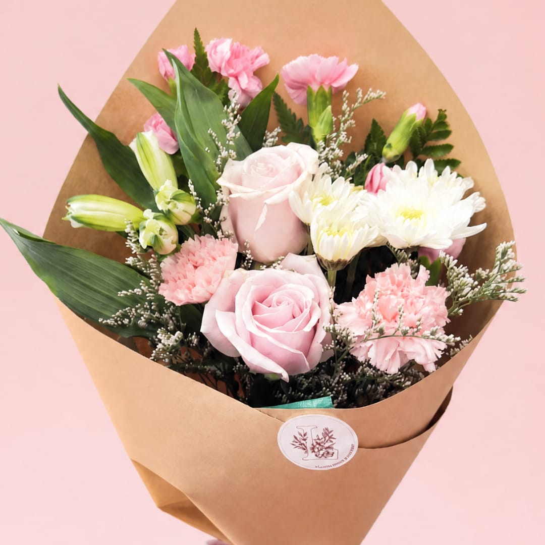 Pink and white mixed bouquet wrapped in brown paper
