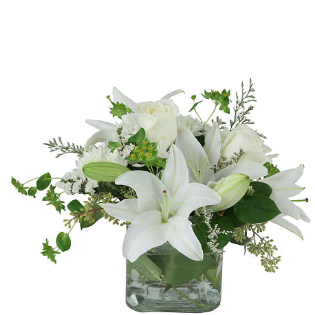 White lilies and roses in a square glass vase