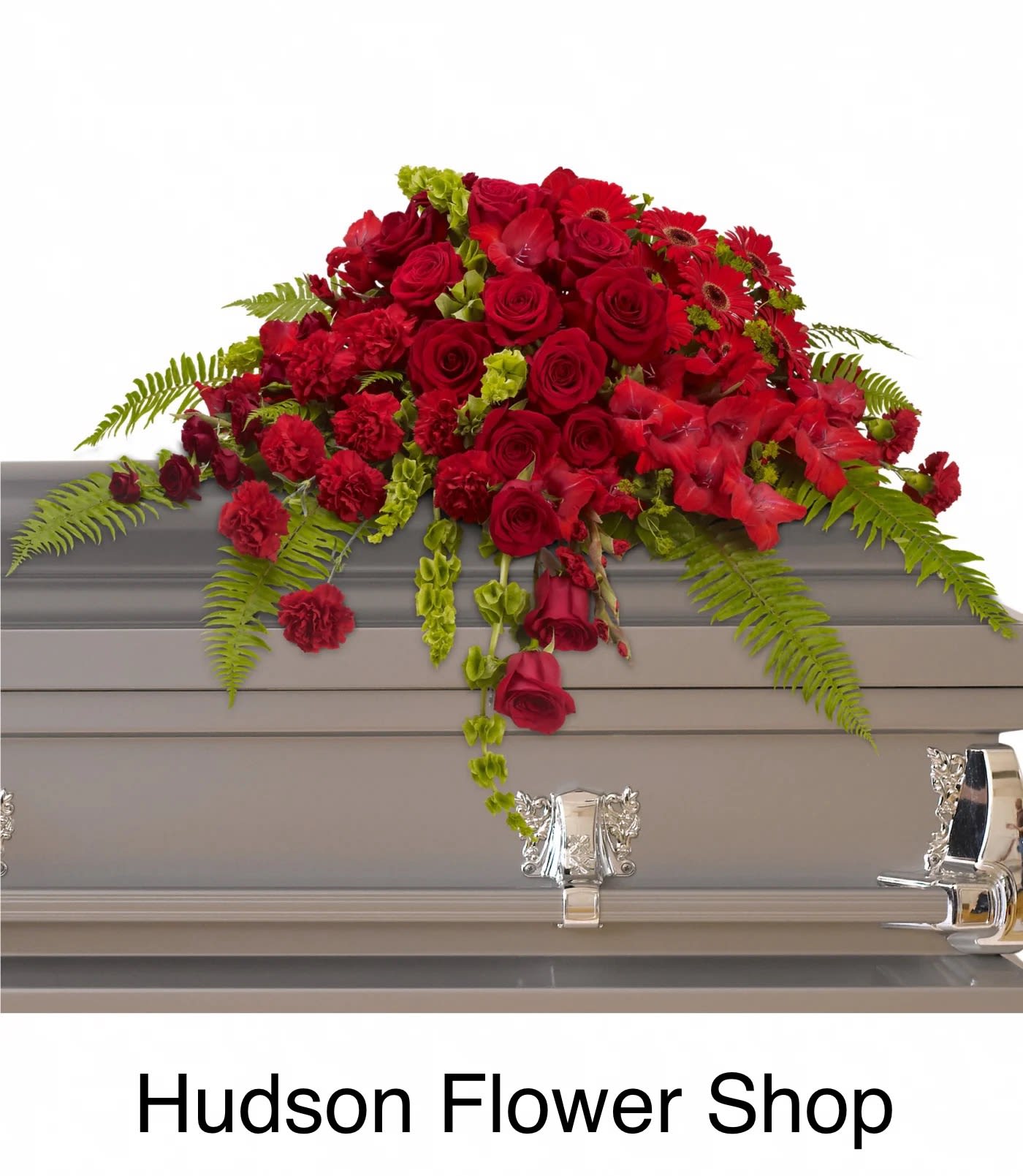 Red floral casket spray with roses, gerbera daisies, and carnations