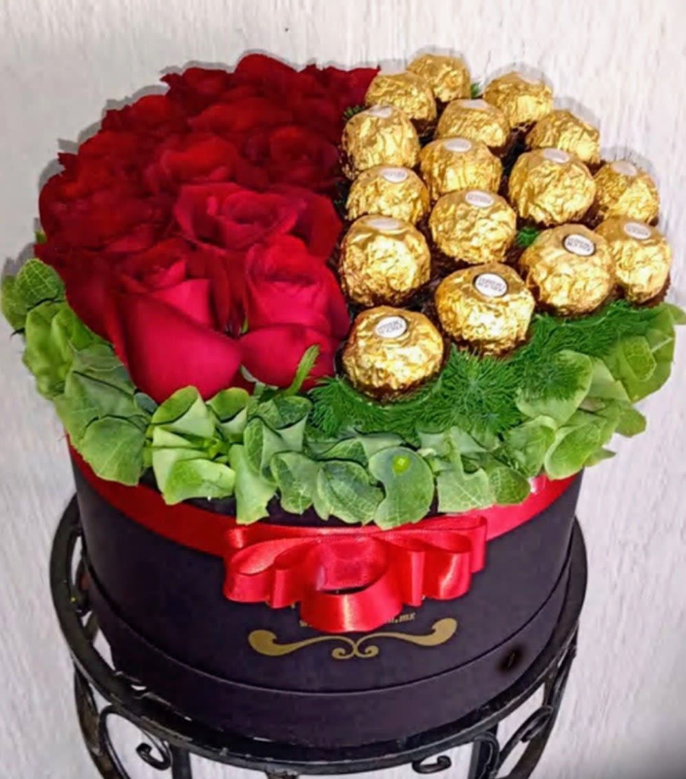Golden Romance Rose Box - Luxury flower arrangement handcrafted with premium red roses, Ferrero Rocher chocolates, decorative greenery and elegant presentation box by Snyder Flower Shop in San Antonio TX. Perfect for anniversaries, birthdays, Valentine’s Day, romantic surprises, proposals and special occasions with same day flower delivery in San Antonio. Our local florist specializes in custom rose arrangements, luxury flower boxes and premium floral gifts designed fresh daily.
