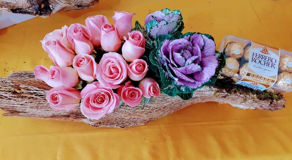 Rose &amp; Ferrero Gift - Surprise someone special with this elegant pink rose and Ferrero Rocher gift arrangement, handcrafted by Snyder Flowers in San Antonio, Texas. Featuring premium pink roses, decorative ornamental cabbage, gourmet Ferrero Rocher chocolates, and natural rustic accents, this unique floral design is perfect for anniversaries, birthdays, Valentine's Day, Mother's Day, congratulations, thank you gifts, and romantic occasions. Our fresh flowers are carefully selected to create a memorable luxury flower gift that stands out from traditional bouquets. Same-day flower delivery available throughout San Antonio, Stone Oak, Alamo Heights, Medical Center, Shavano Park, Helotes, Schertz, Cibolo, Bulverde, and surrounding areas.