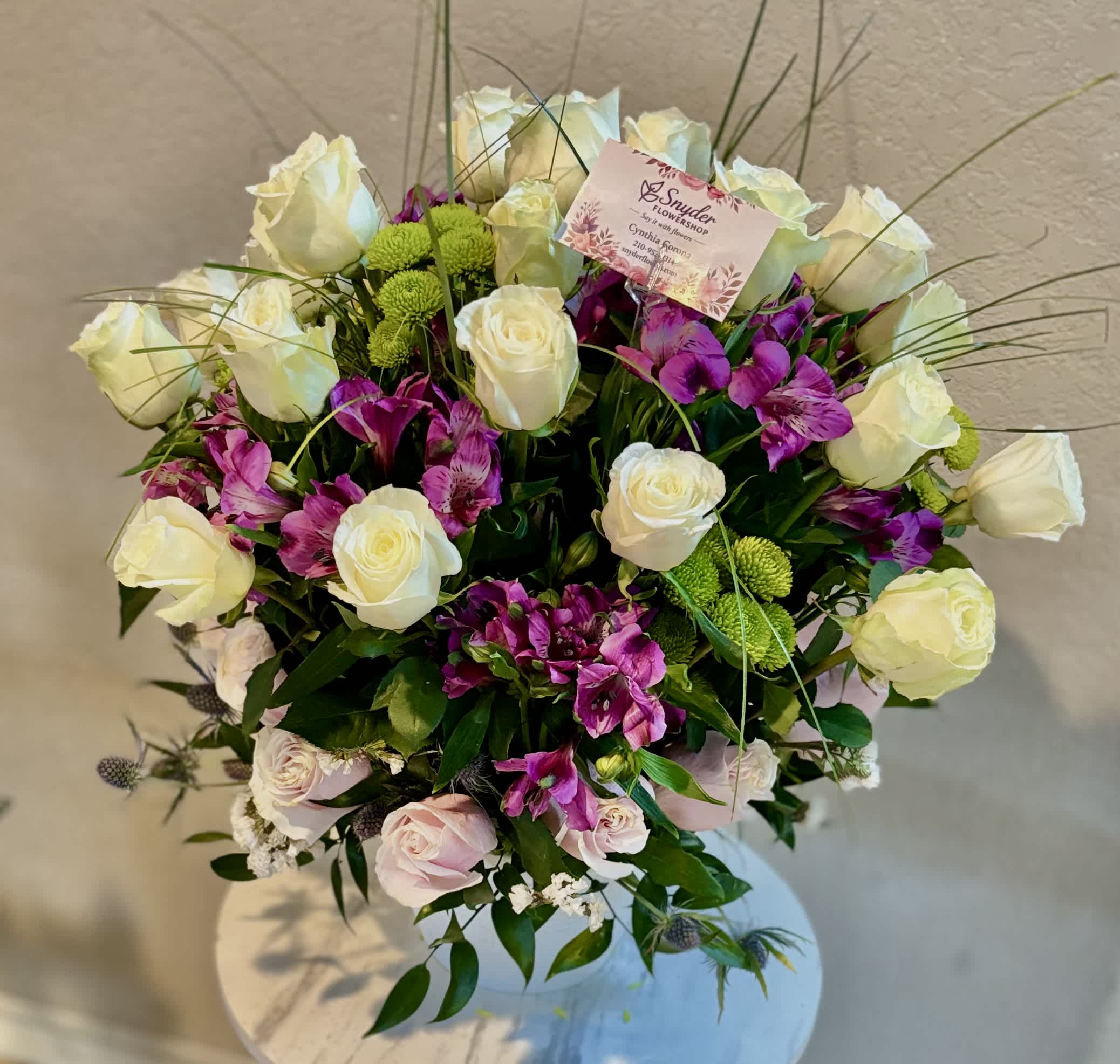 Bouquet of white roses and purple alstroemeria with green button mums