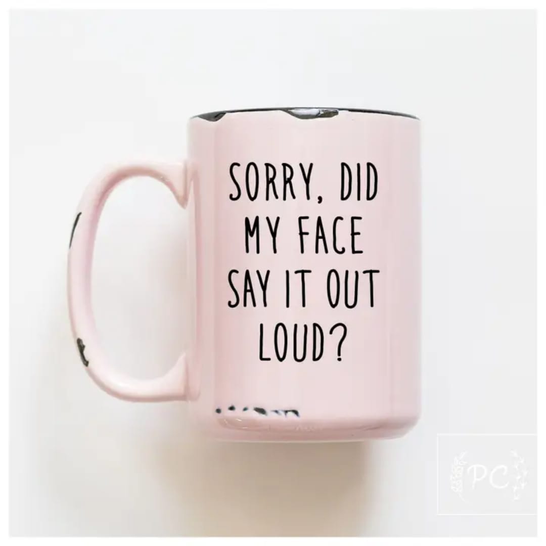 Pink mug with black text on a white background