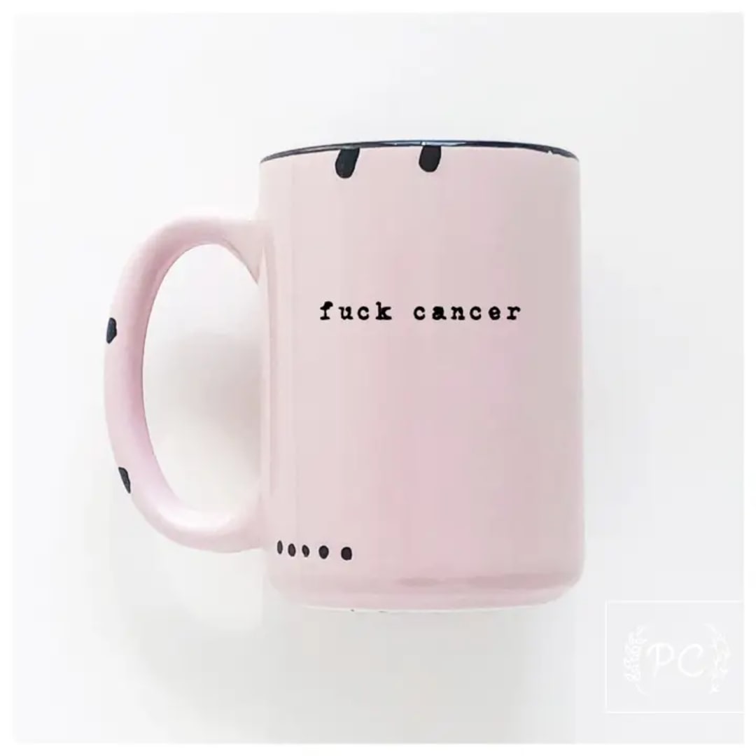 Pink mug with black text and dot accents