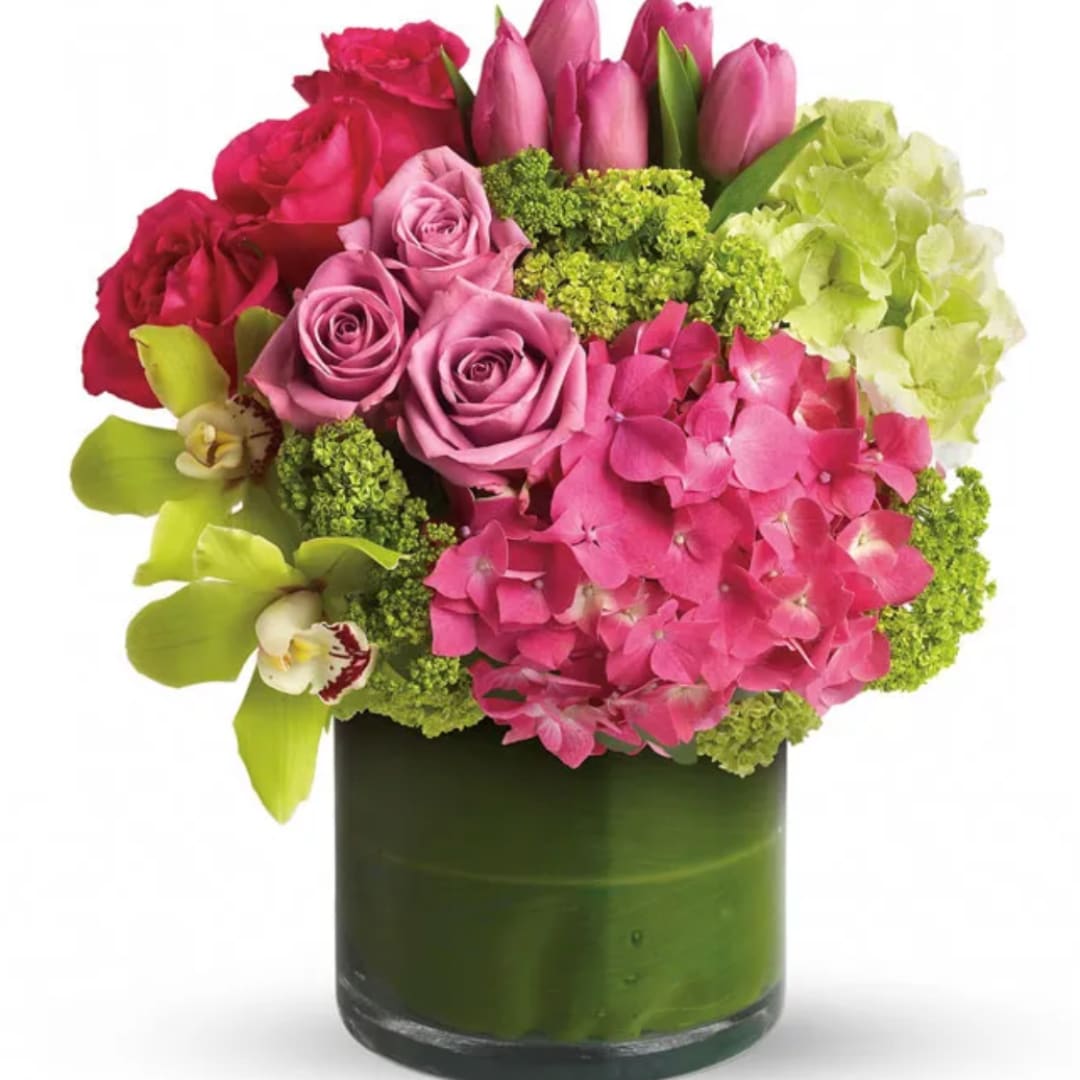 Pink roses and hydrangeas with orchids in a green vase