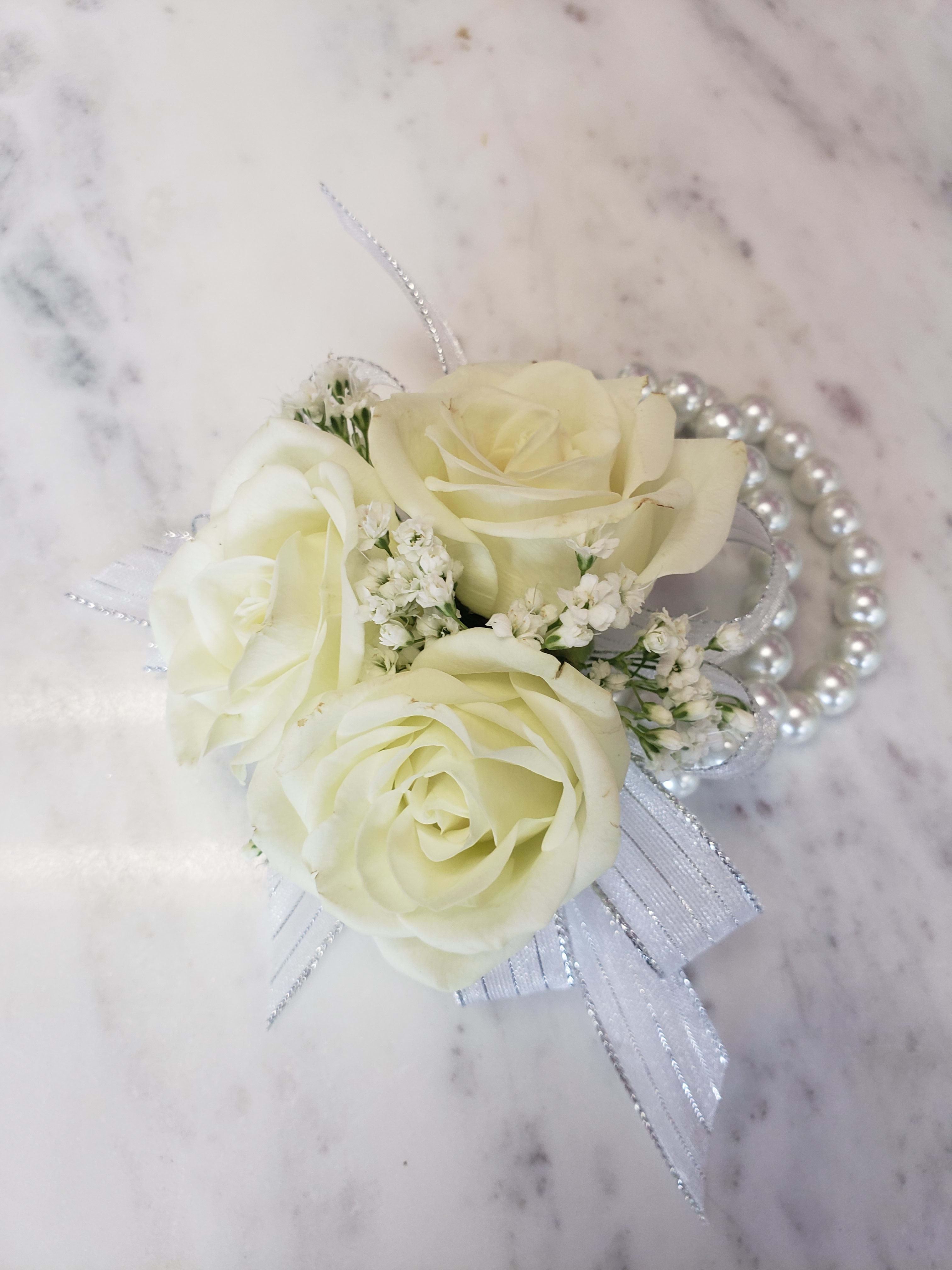 White rose corsage with pearl accents and ribbon