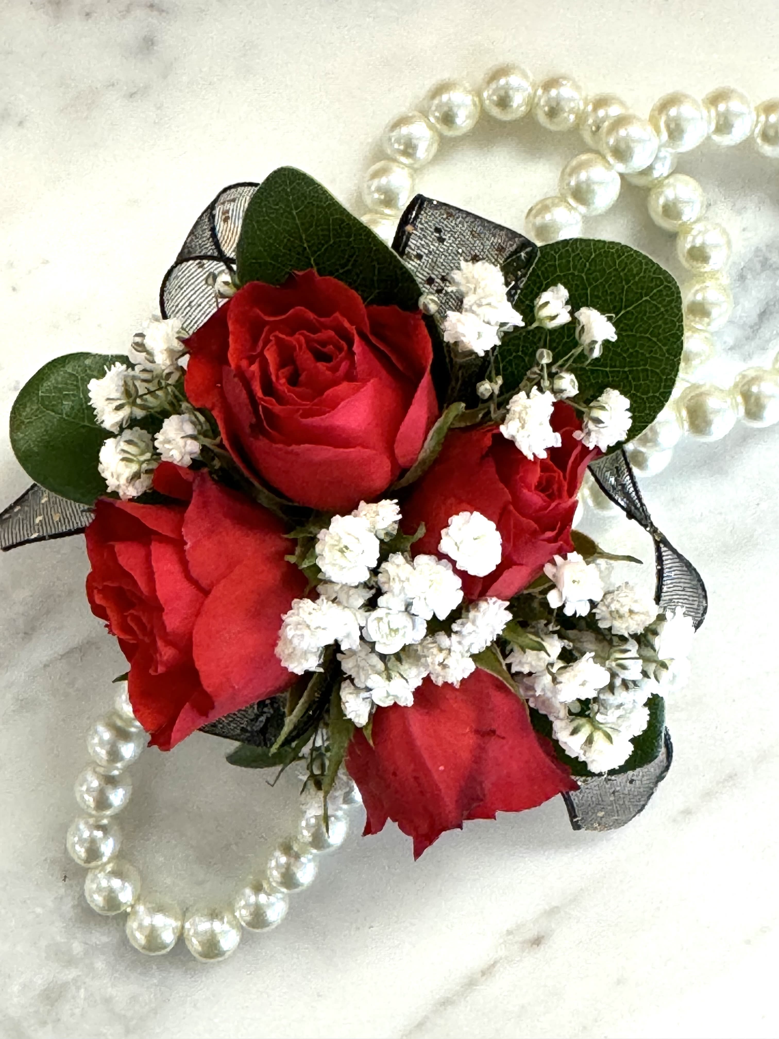 Red rose corsage with white baby's breath and pearl accents