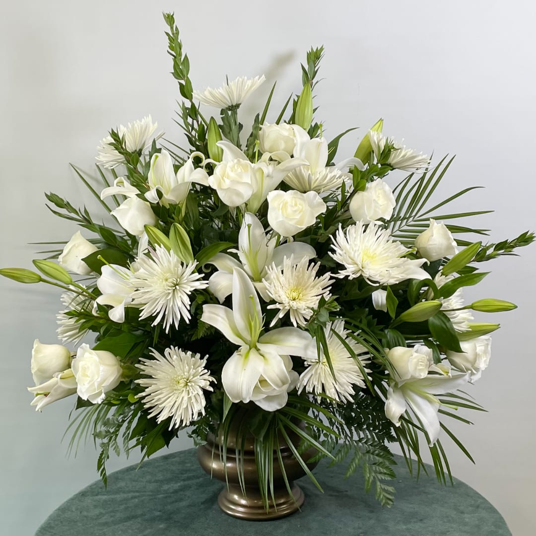 White floral arrangement in a bronze vase