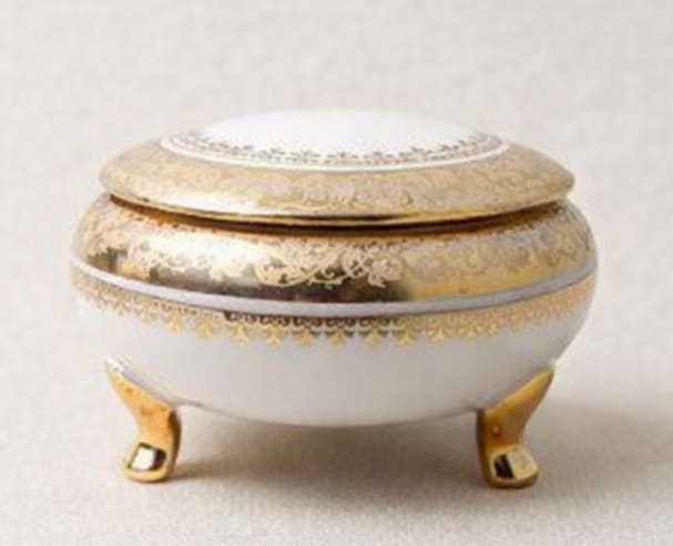 Decorative white and gold lidded trinket box on small feet