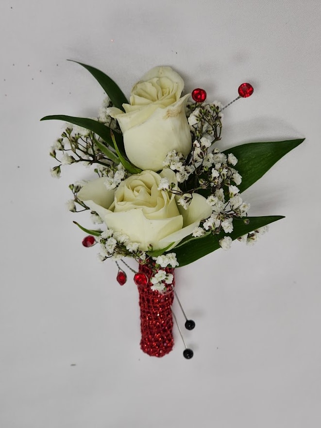 Scarlett Gems Boutonierre - Select this boutonierre featuring spray roses and babies breathe with accents of red rhinestones and red ribbon. Each boutonniere comes with two metal pins to pin on a jacket lapel or shirt. Exact flowers may vary. 