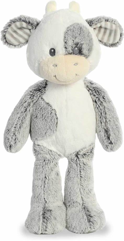 Gray and white plush cow stuffed animal with a smiling face