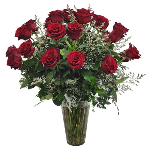 Red roses arranged in a clear glass vase