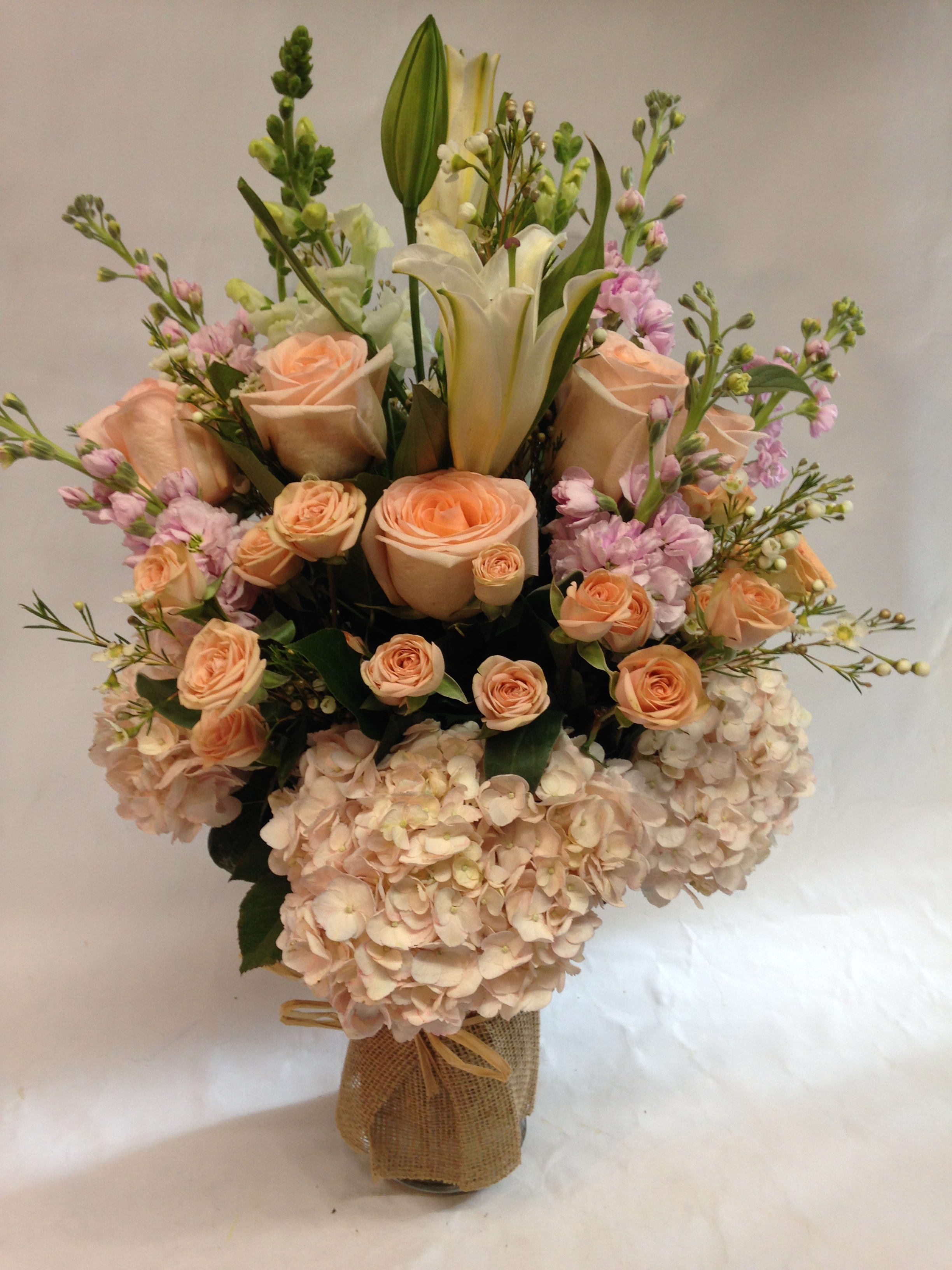 Blushing Pink - This arrangement comes in shades of light pink and white, complete with hydrangeas, roses, snap dragons, lilies, stock and wax.  (Some flowers may be subject to change depending on the season. We will contact you with available flower substitutions; please contact us with specific questions if you are concerned with flower availability, thanks!)  Featured arrangement:450.00 (Regular Price)
