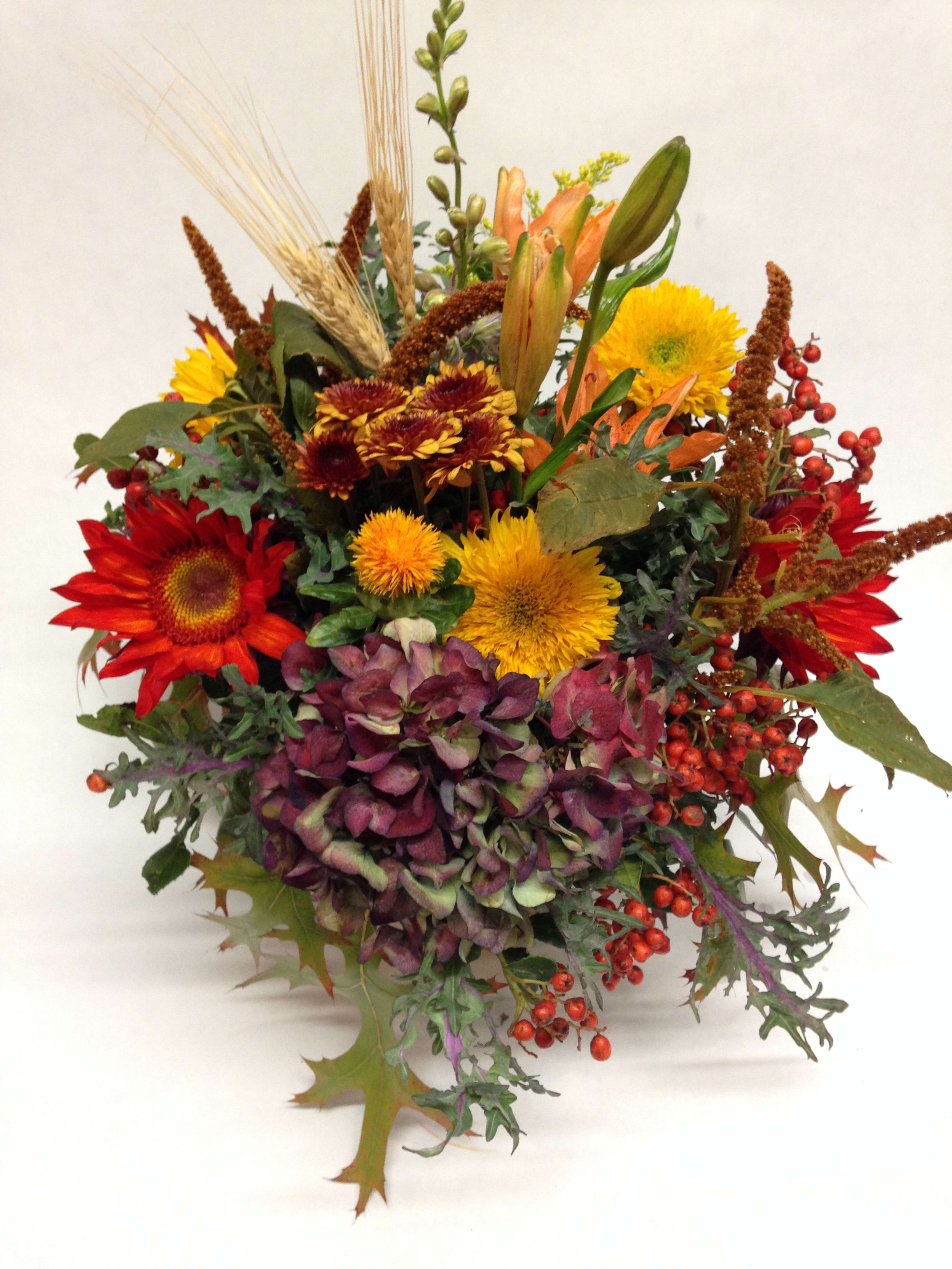 Autumn bouquet with red and yellow flowers and purple hydrangea