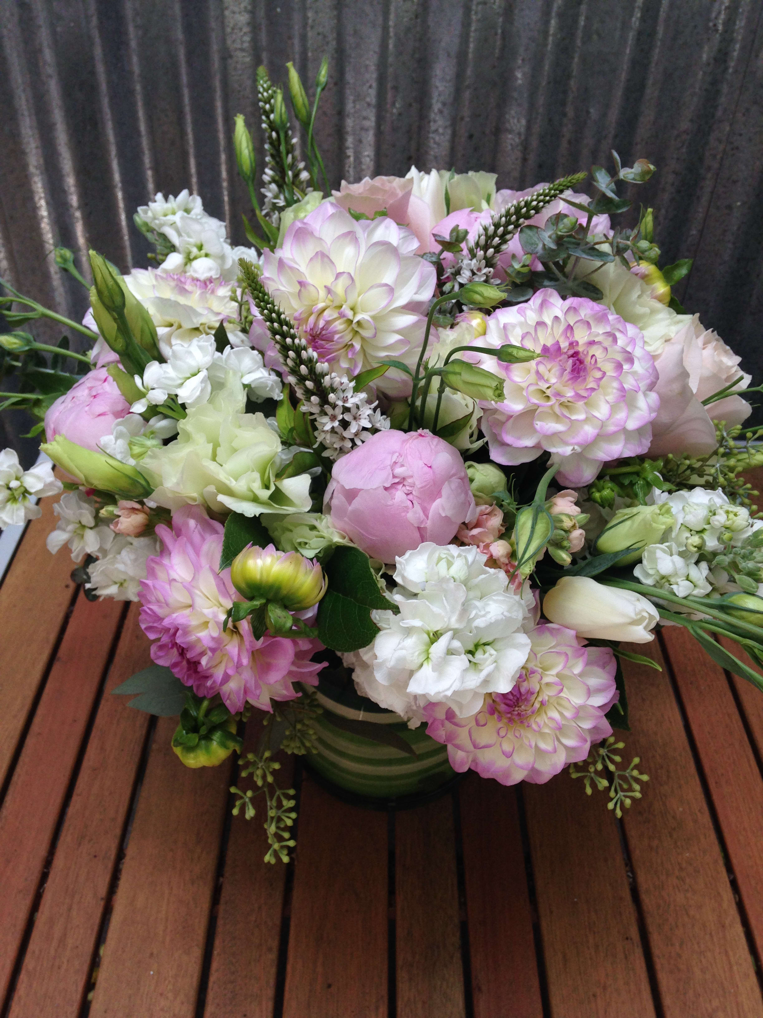 Pink and white mixed bouquet in a green vase