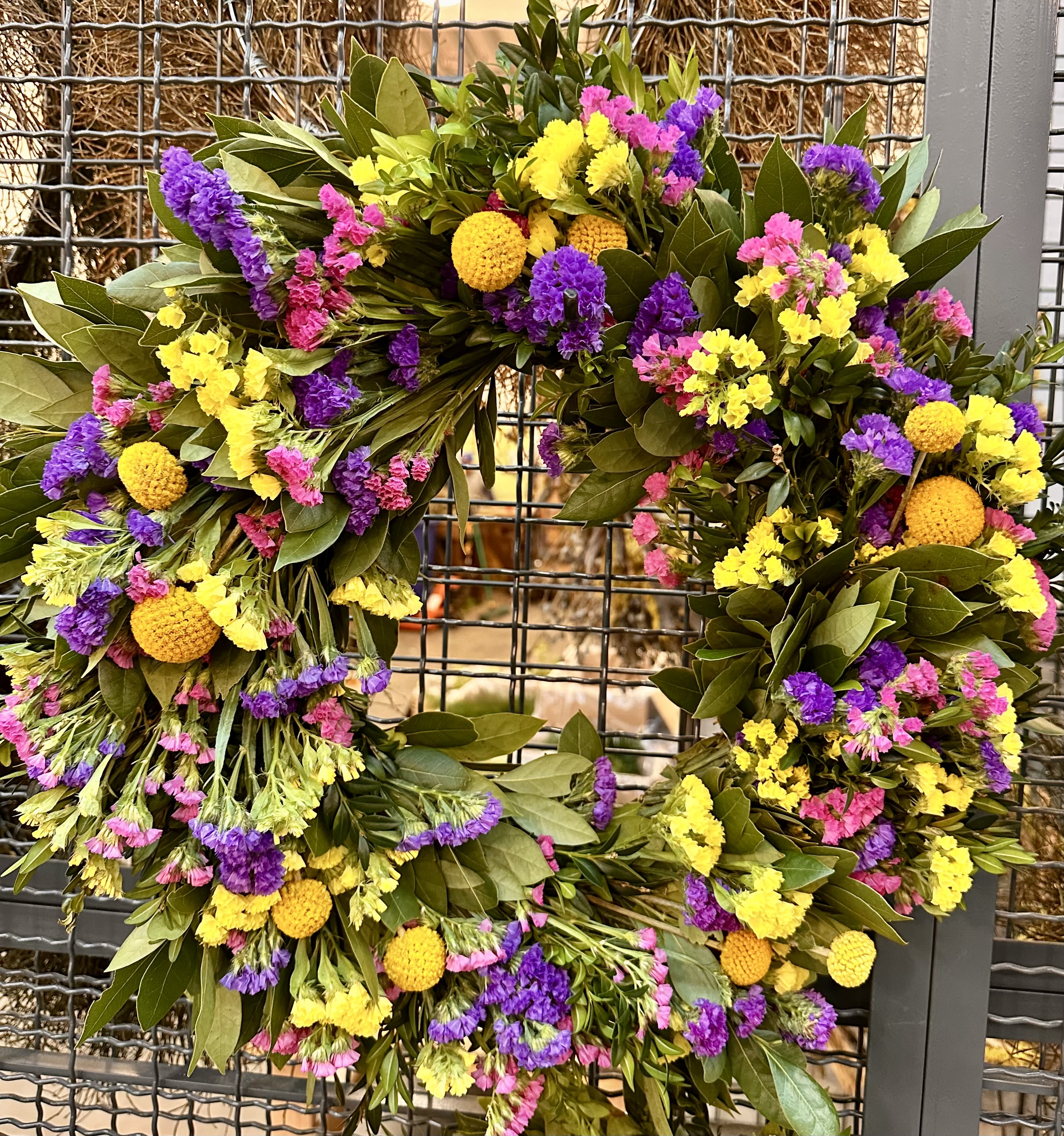Colorful floral wreath with yellow, purple, and pink blooms