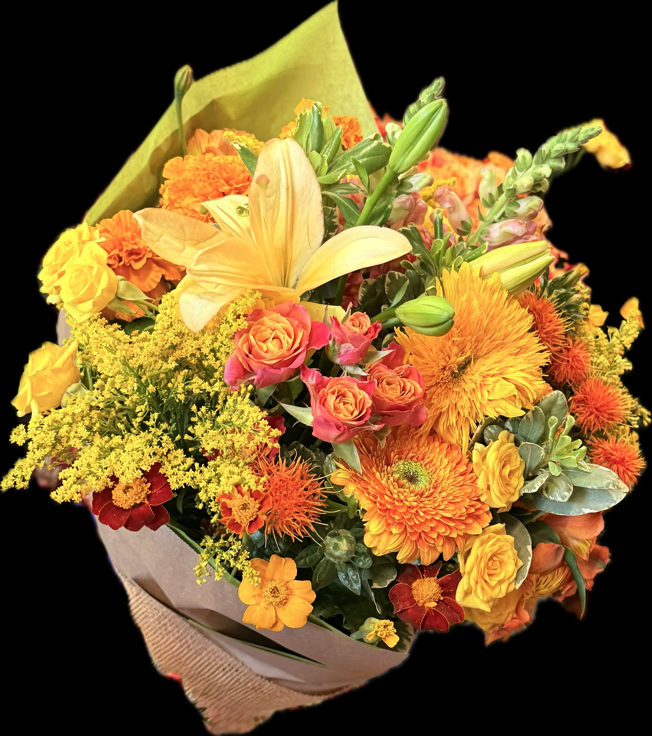Bouquet of orange, yellow, and pink flowers wrapped in paper