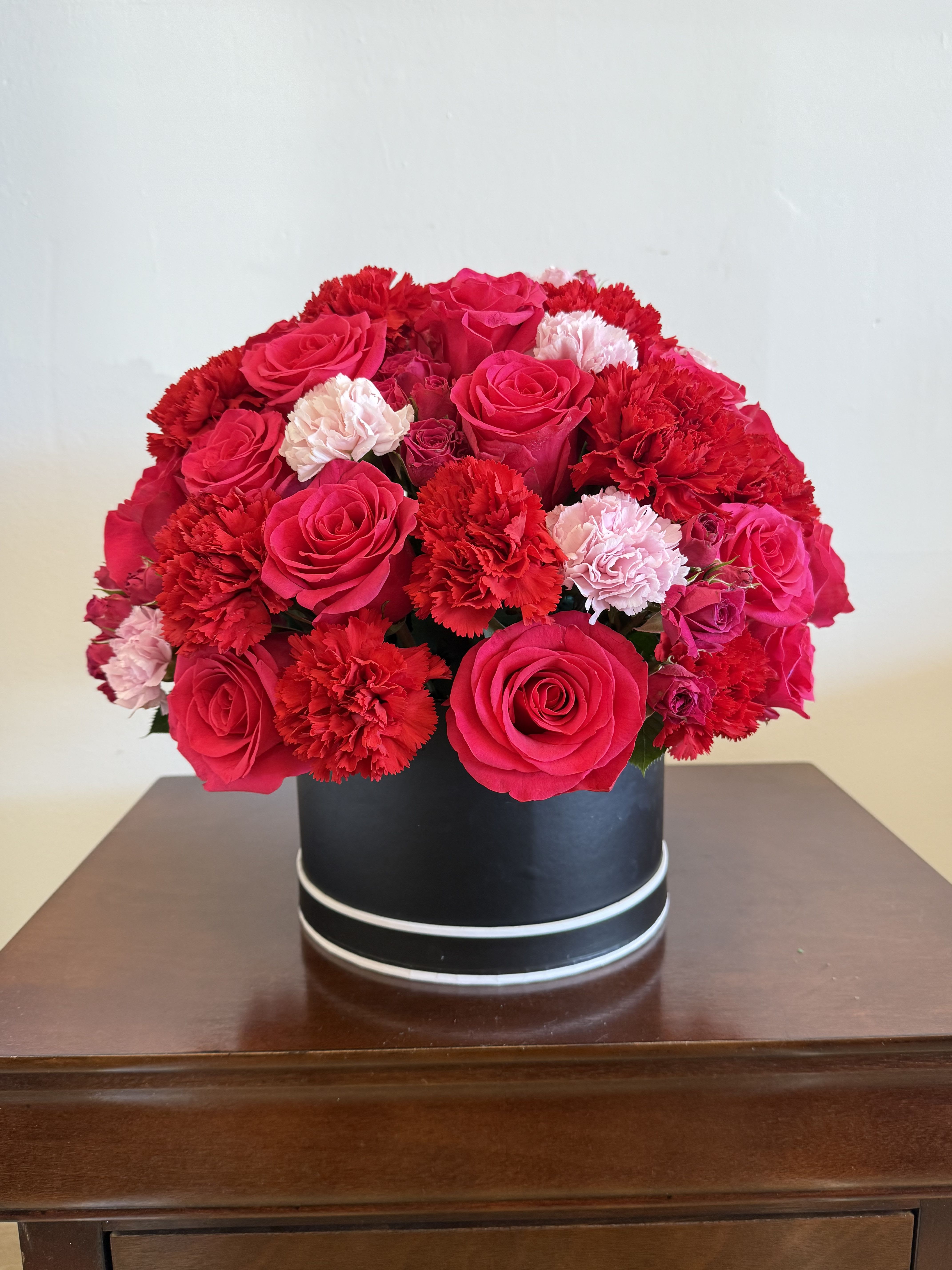 BLOOM PINK SPRING  - This arrangement is topped with 20-25 roses along the way of fine seasonal mix. 