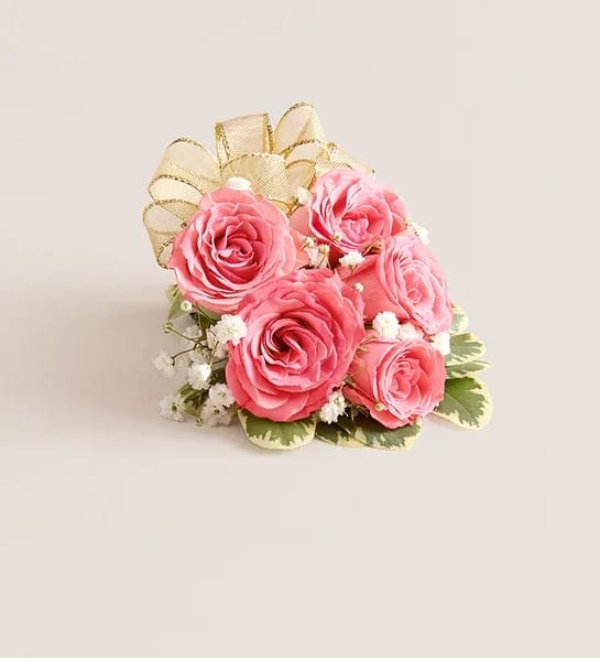 Pink Spray Rose Corsage - NEW A dreamy finishing touch to a wedding gown, a prom dress, or any other special-occasion finery. Consisting of carefully selected pink spray roses complemented with baby’s-breath and greenery, our corsage comes with ribbon in your choice of seven colors: black, gold, light blue, light pink, purple, silver, or white