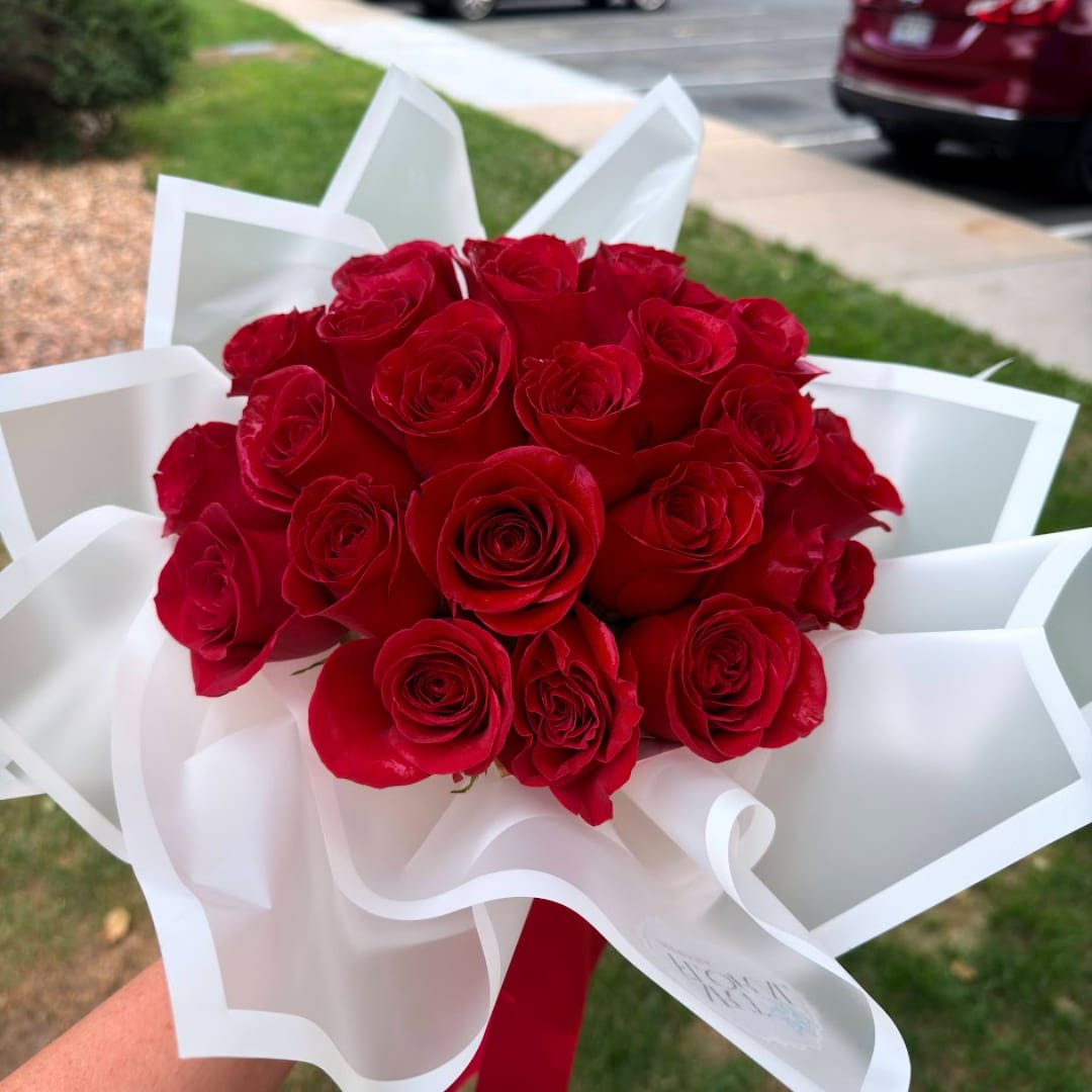 Bouquet of red roses wrapped in white paper