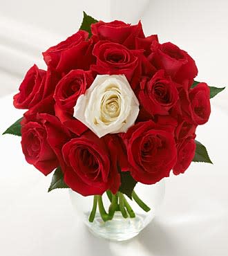 You are the one  - How best to show your sweetheart that she or he is unique? With this unique bouquet of roses in red  with a single magnificent white rose in the center! The perfect romantic flower message! 