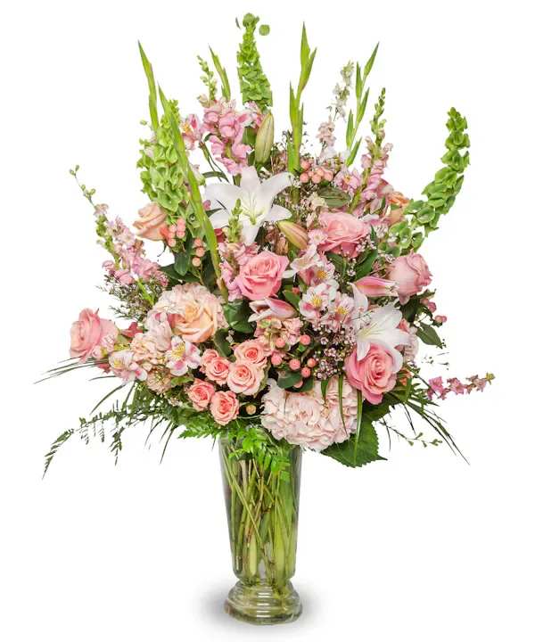 Tall pink and white floral arrangement in a glass vase