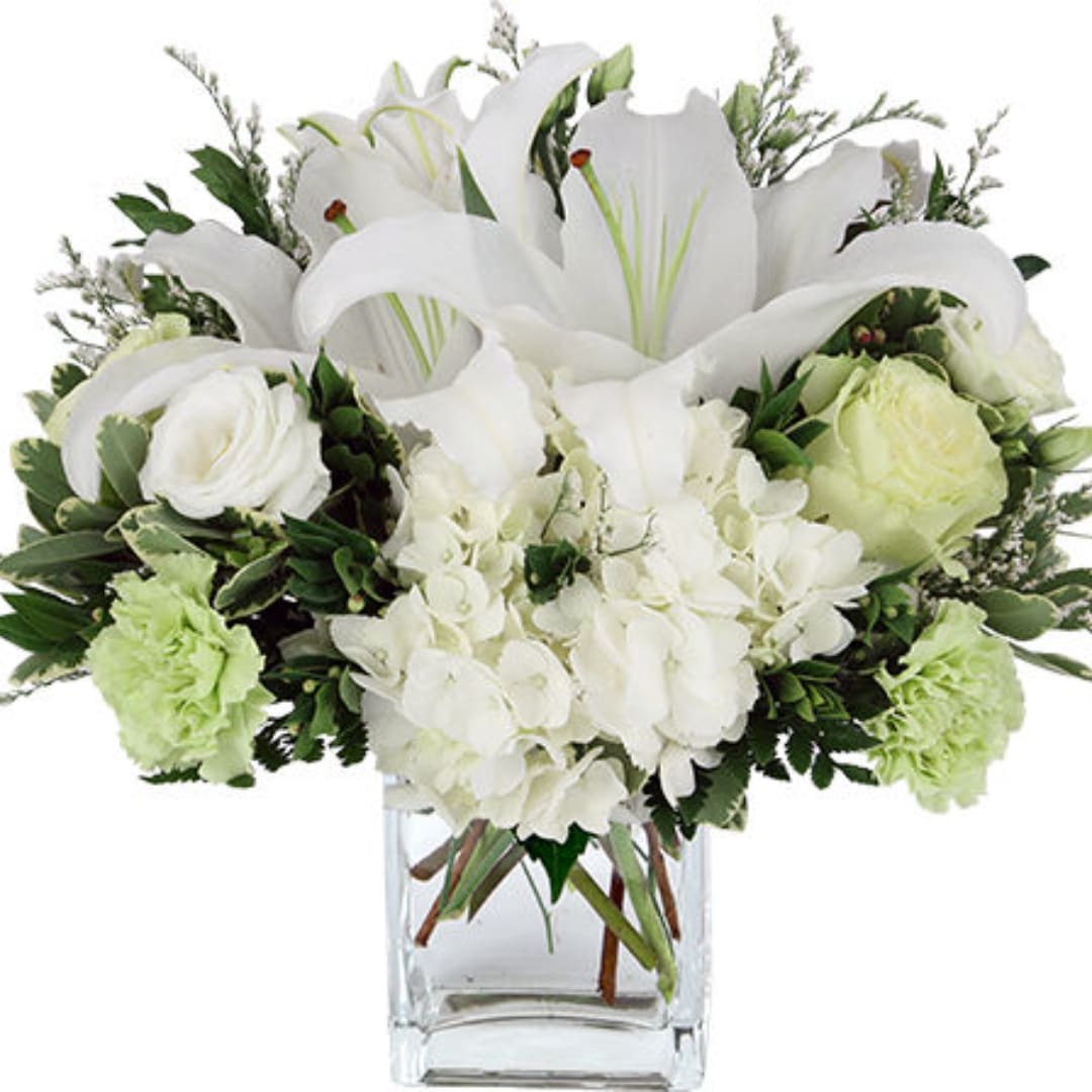 White lilies and roses arranged in a clear glass vase