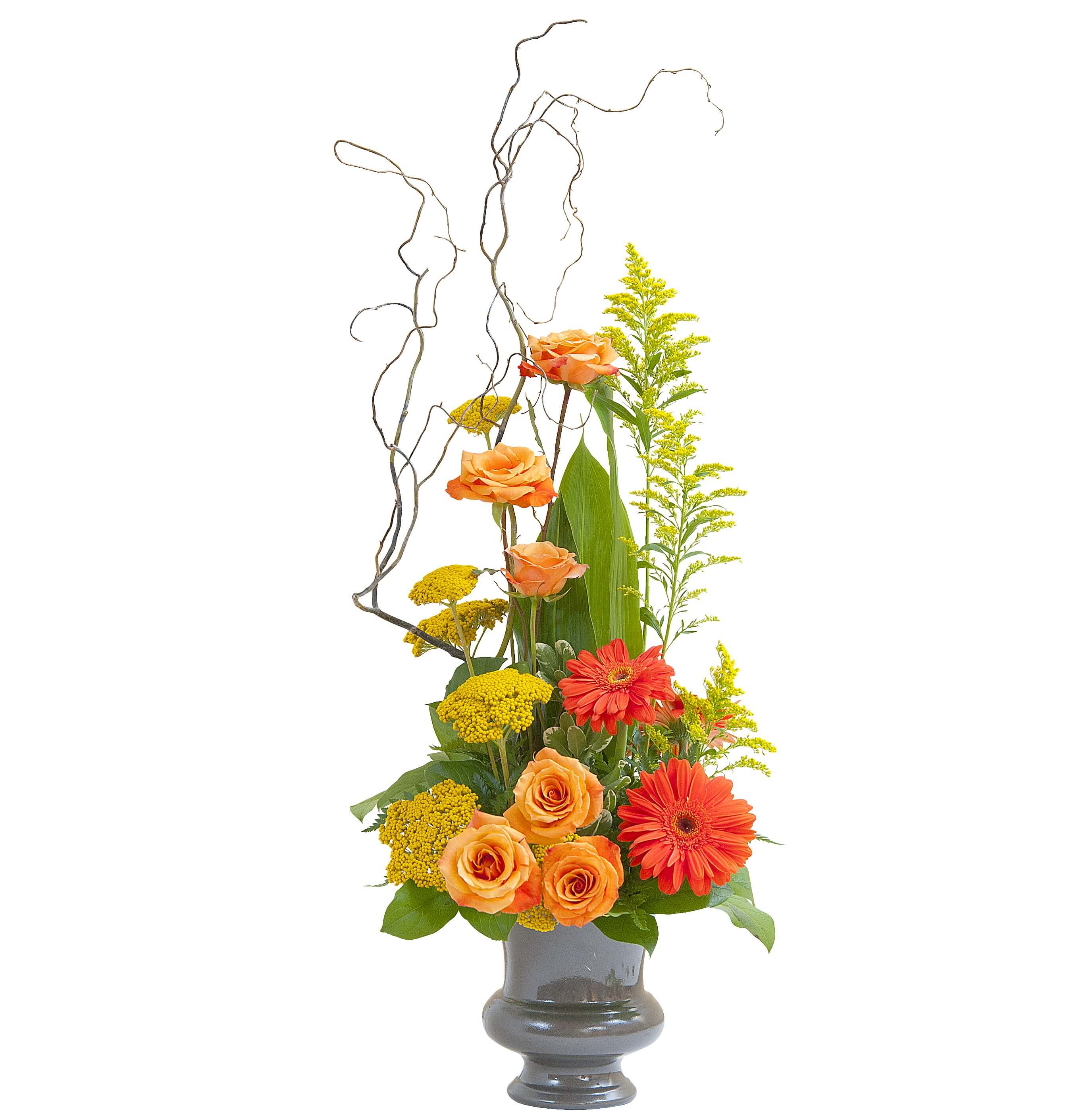 Tall arrangement of orange roses and gerbera daisies with yellow blooms in a gray vase