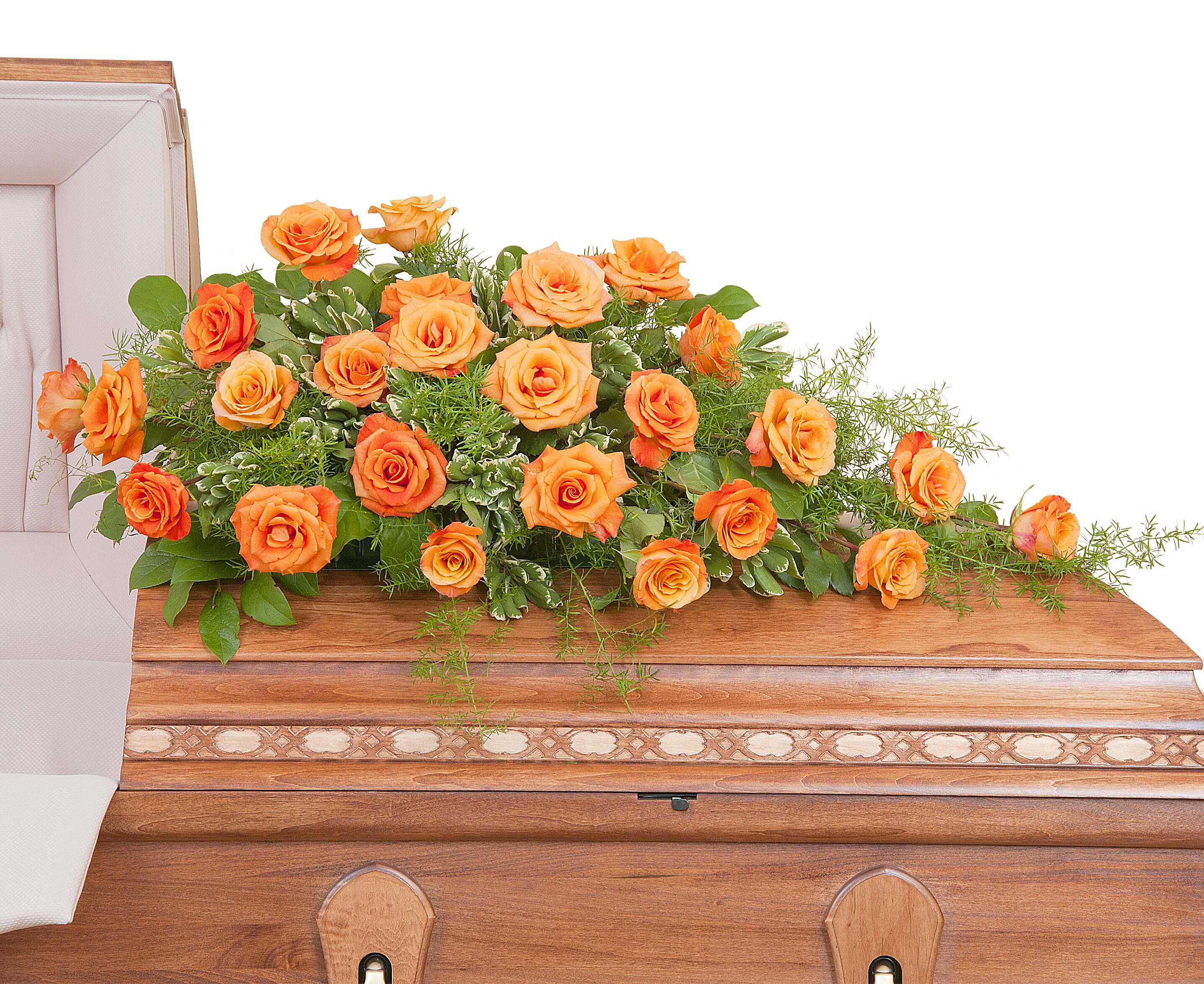 Long spray of orange roses arranged on top of a wooden casket