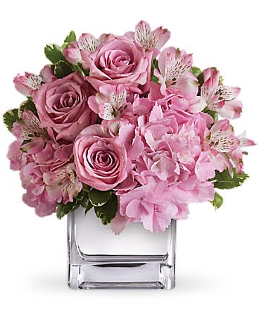 Low pink rose, alstroemeria, and hydrangea arrangement in a clear glass cube vase