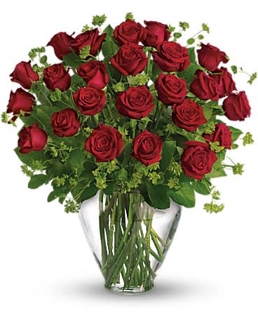 Large bouquet of long-stemmed red roses with green filler in a clear glass vase