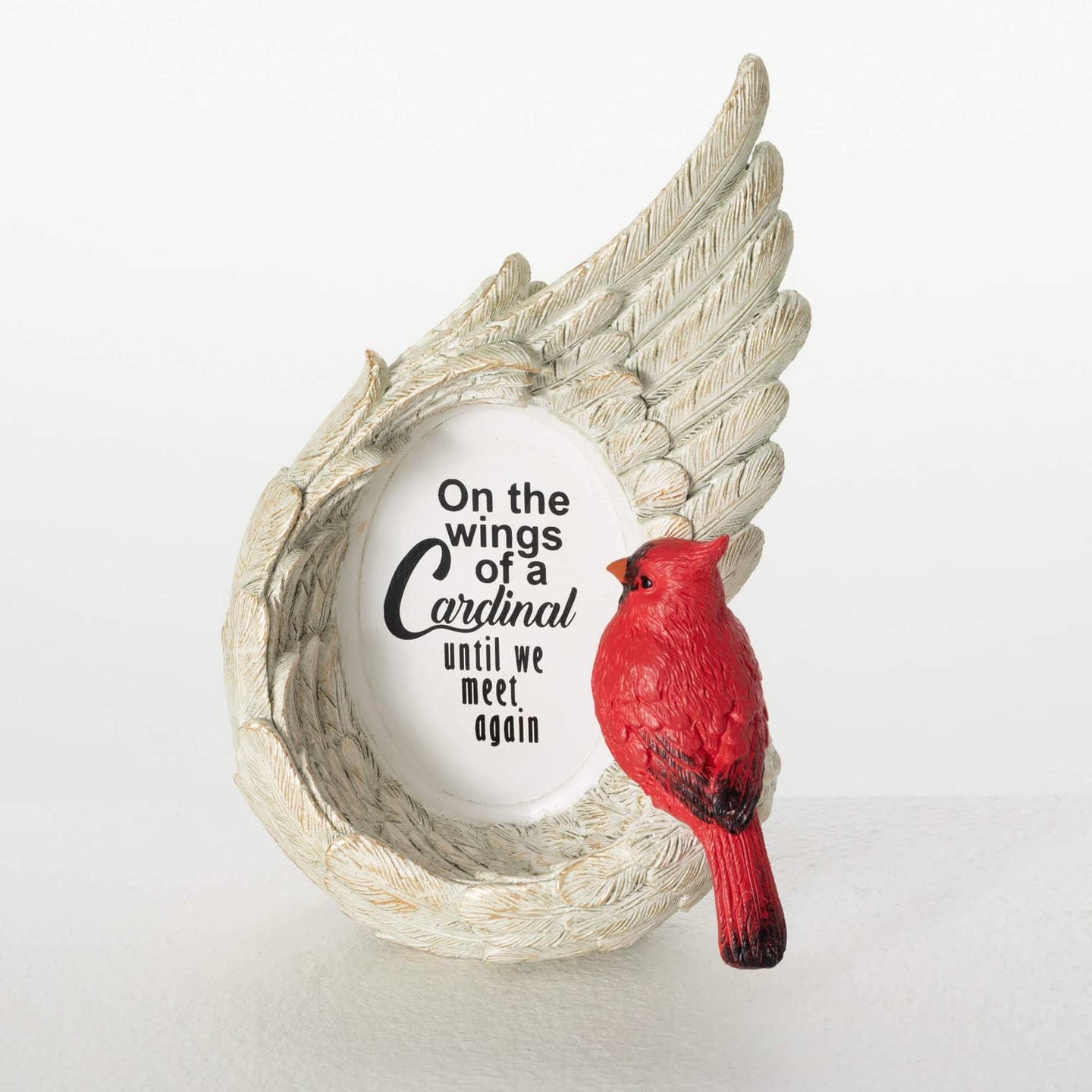 Cardinal memorial plaque with angel wings and a red bird figurine