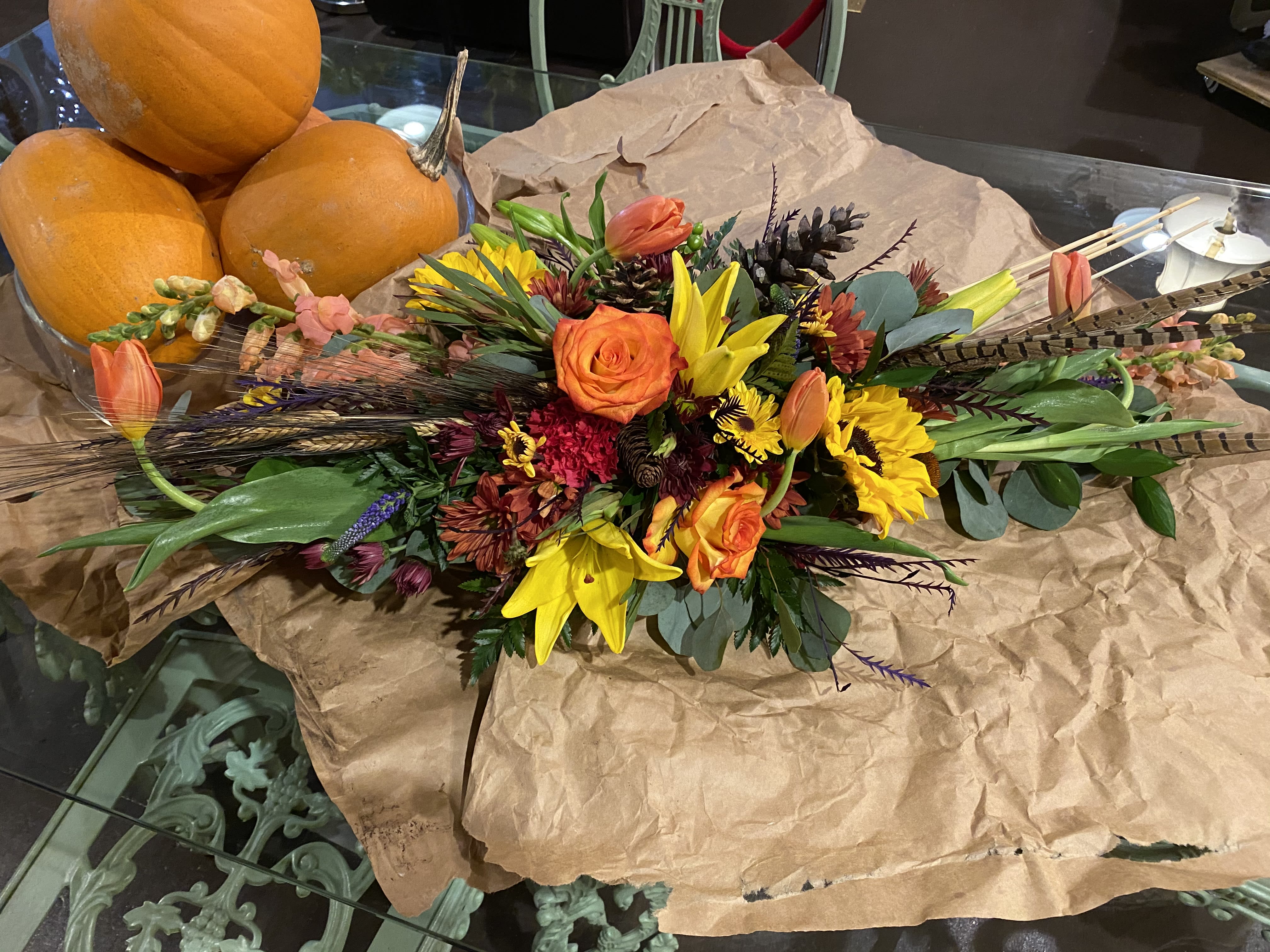 Harvest Bounty - Gathering around the table to give thanks, seems to mean more and more each year. This year, give thanks with your family around a bountiful centerpiece, featuring a combination of fresh floral and naturally dried materiels - no two centerpieces will be the same, the image is merely an example of how fabulous your tablescape can become. Compliments not included, but are sure to be on the menu!  (Image shown is an example of the Premium option, florals only included, all orders are a designer's choice combination of fall floral and drieds - let us create with you and bring Harvest home or send some Harvest cheer in your absence.)