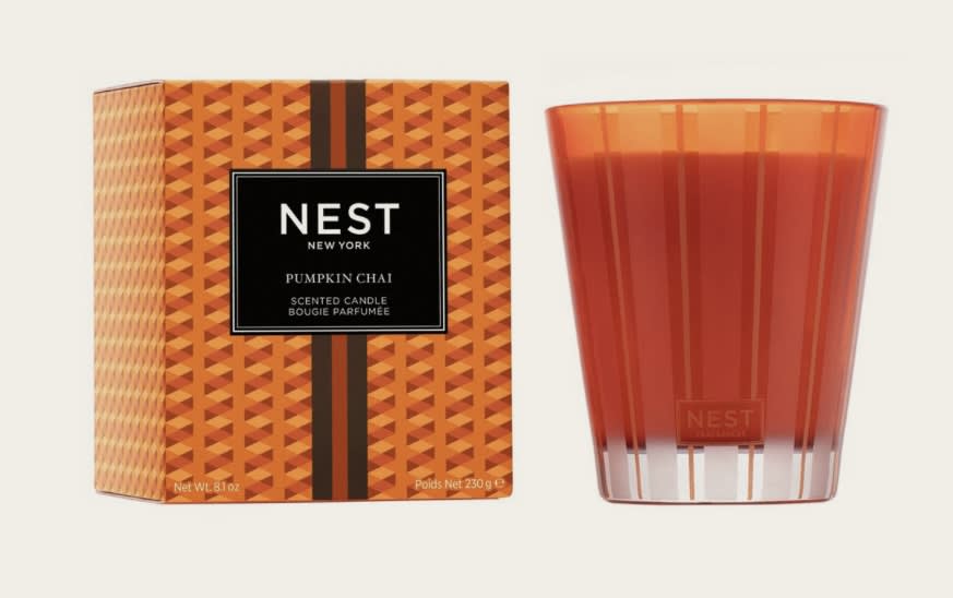 Pumpkin Chai Classic Candle - Create a cozy autumn ambiance with this exquisitely fragranced Classic Candle featuring a blend of wild pumpkin, spicy masala chai, cardamom, ginger, and cinnamon. Orange-tinted wax housed in a glass vessel of the same color with elegant gold and frosted stripes. This exquisitely fragranced candle is meticulously crafted with a proprietary premium wax formulated so the candle burns cleanly and evenly and infuses a room with exceptional scent