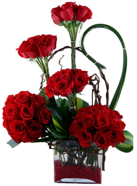 Red rose arrangement in a clear glass vase with decorative loops