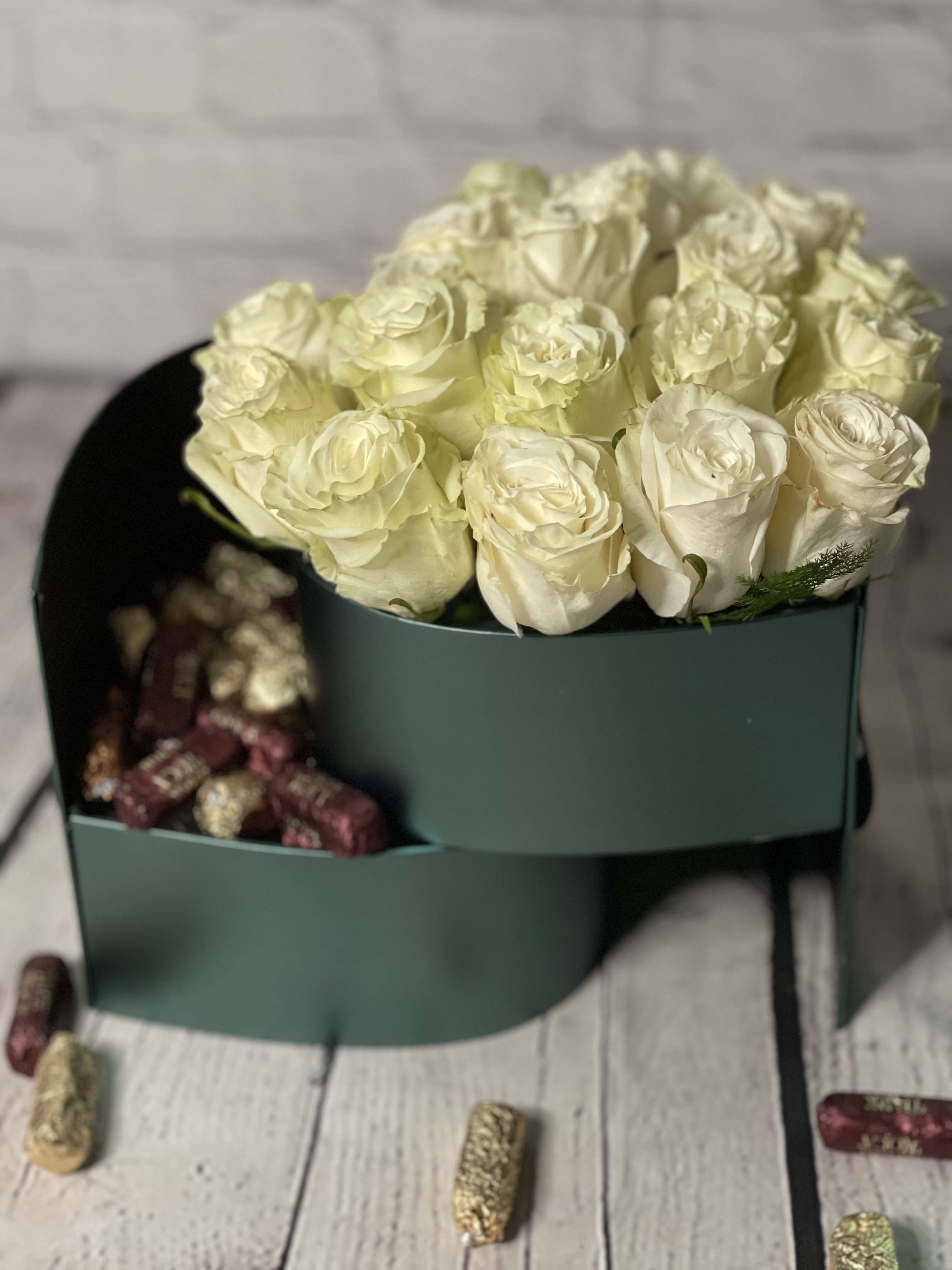 Cream rose bouquet in a dark green box with chocolates