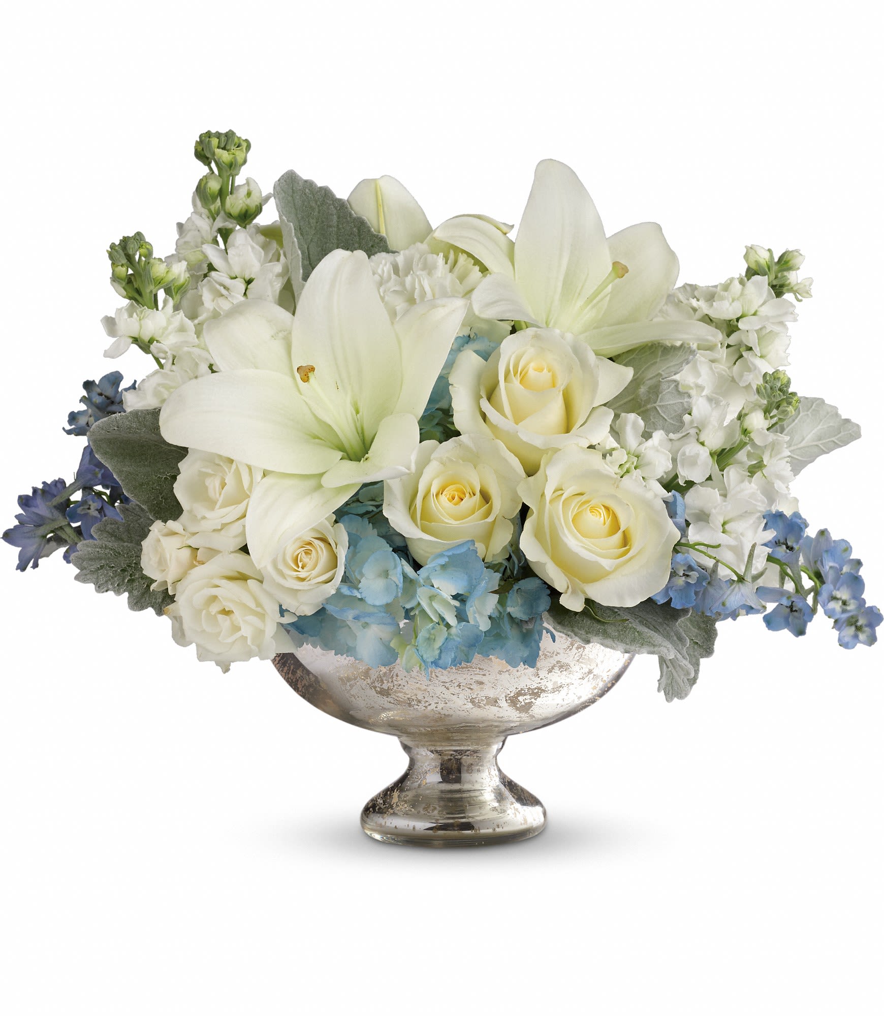 White roses and lilies in a silver pedestal vase with blue accents
